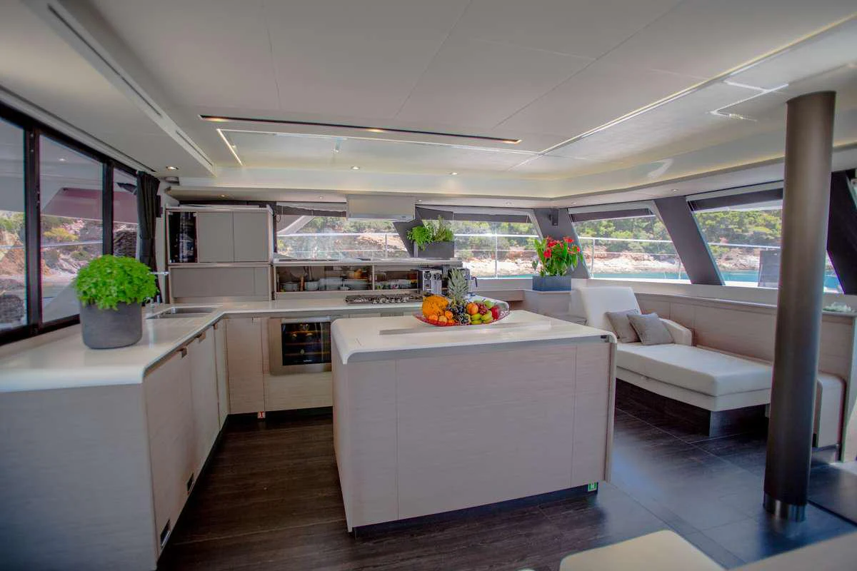 a modern kitchen with white cabinets aboard MAJESTY OF GREECE Yacht for Charter