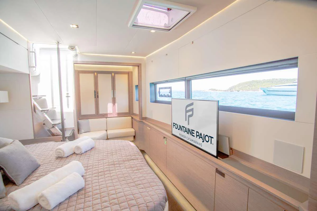 a room with a bed and a tv on the wall aboard MAJESTY OF GREECE Yacht for Charter