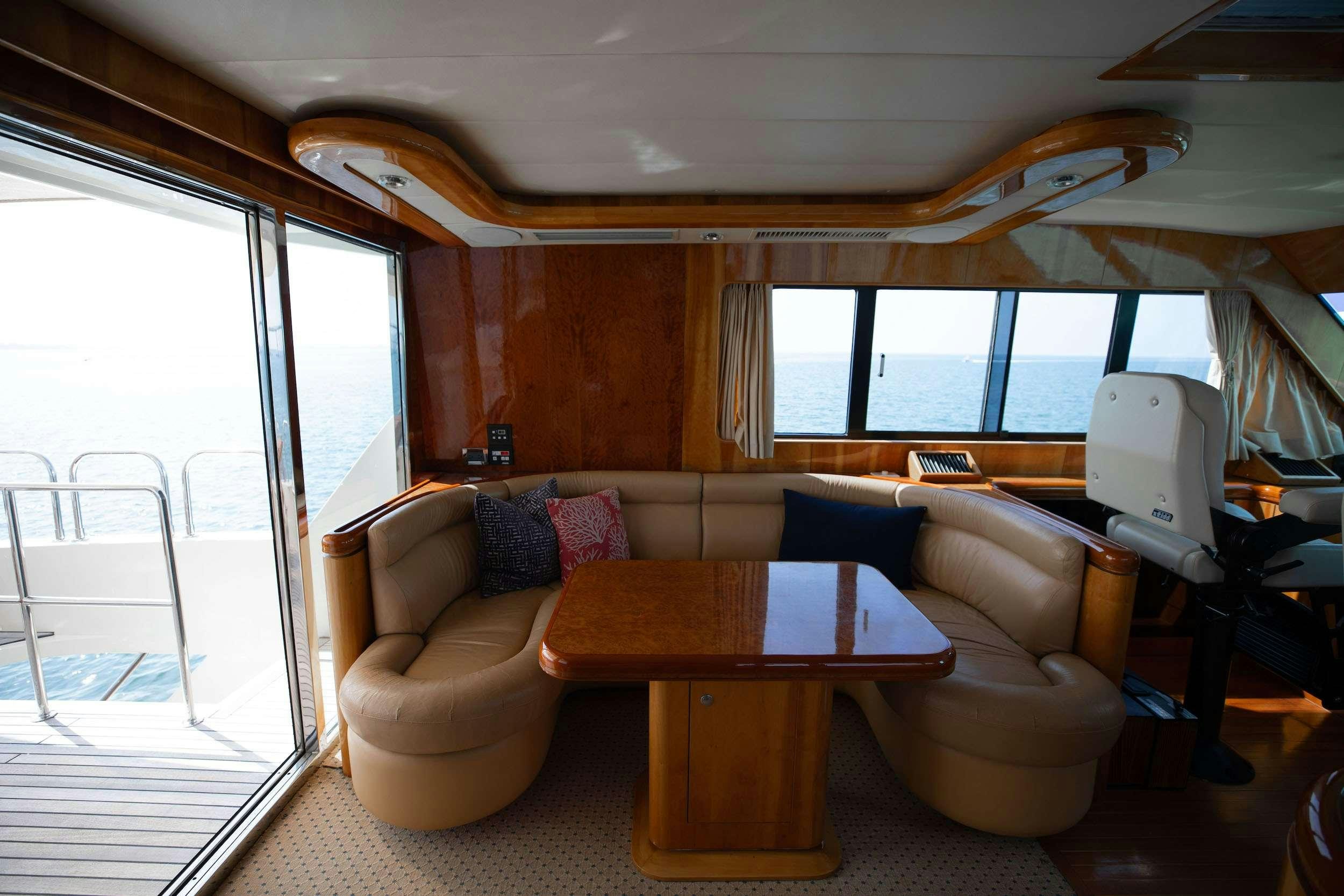 a living room with a table and chairs aboard THE USUAL Yacht for Charter