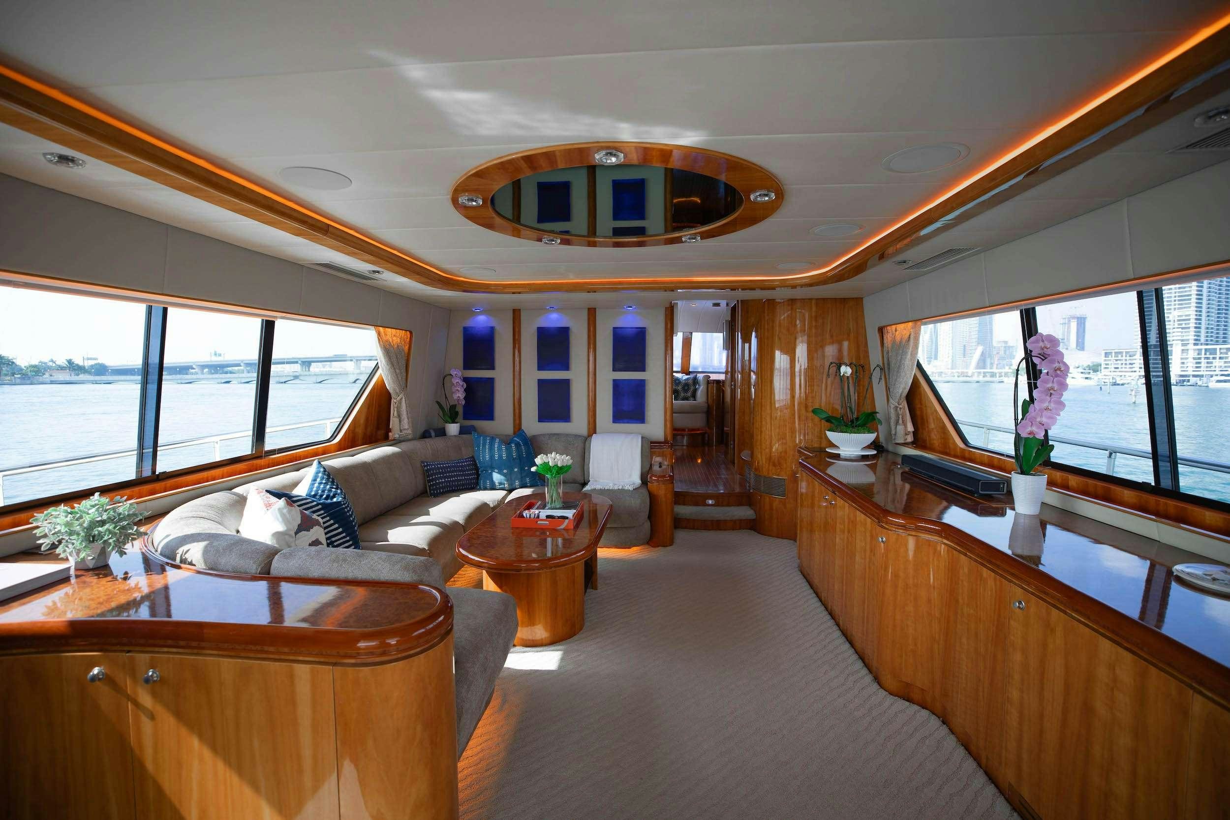 a living room with a large chandelier aboard THE USUAL Yacht for Charter