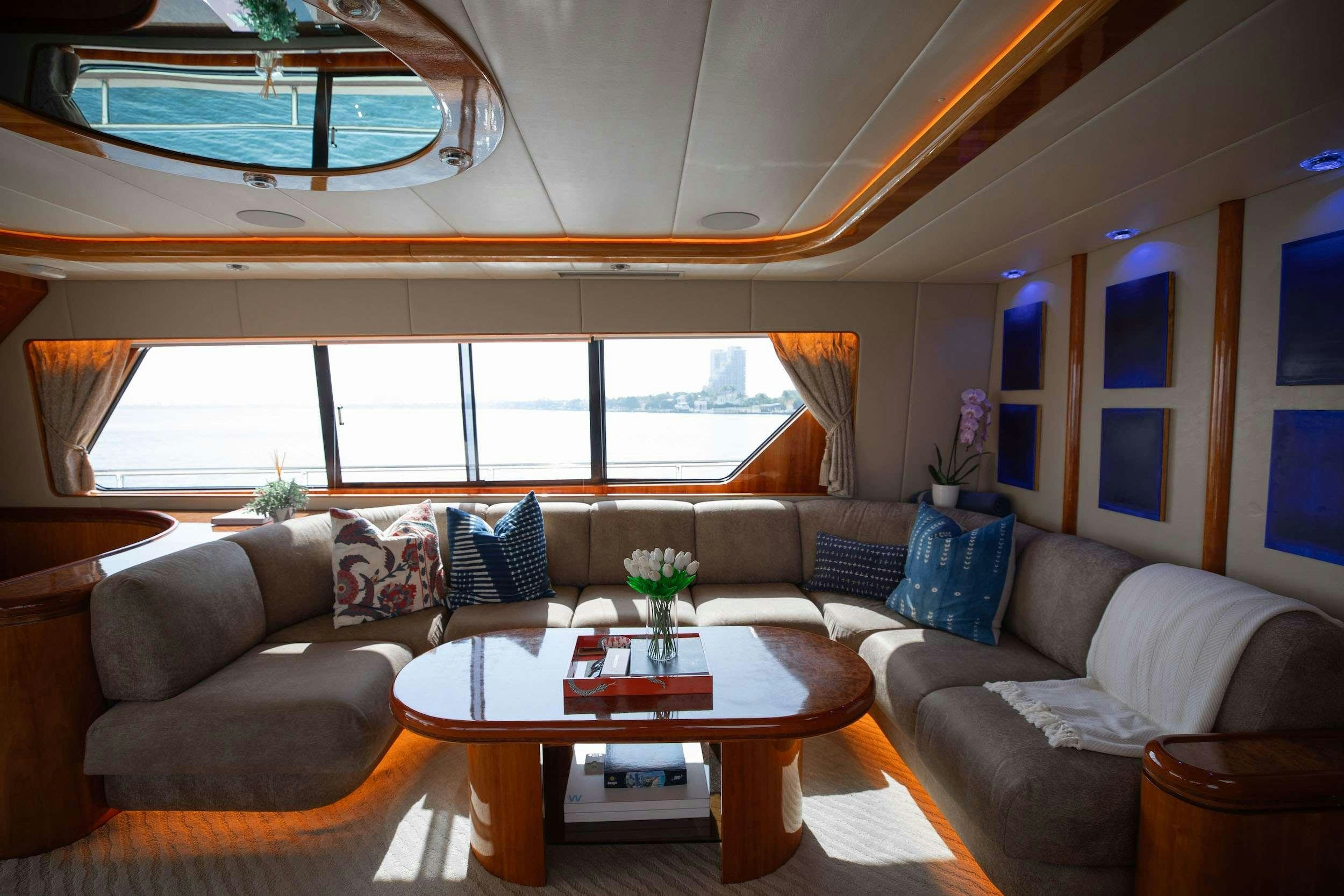a living room with a large window aboard THE USUAL Yacht for Charter