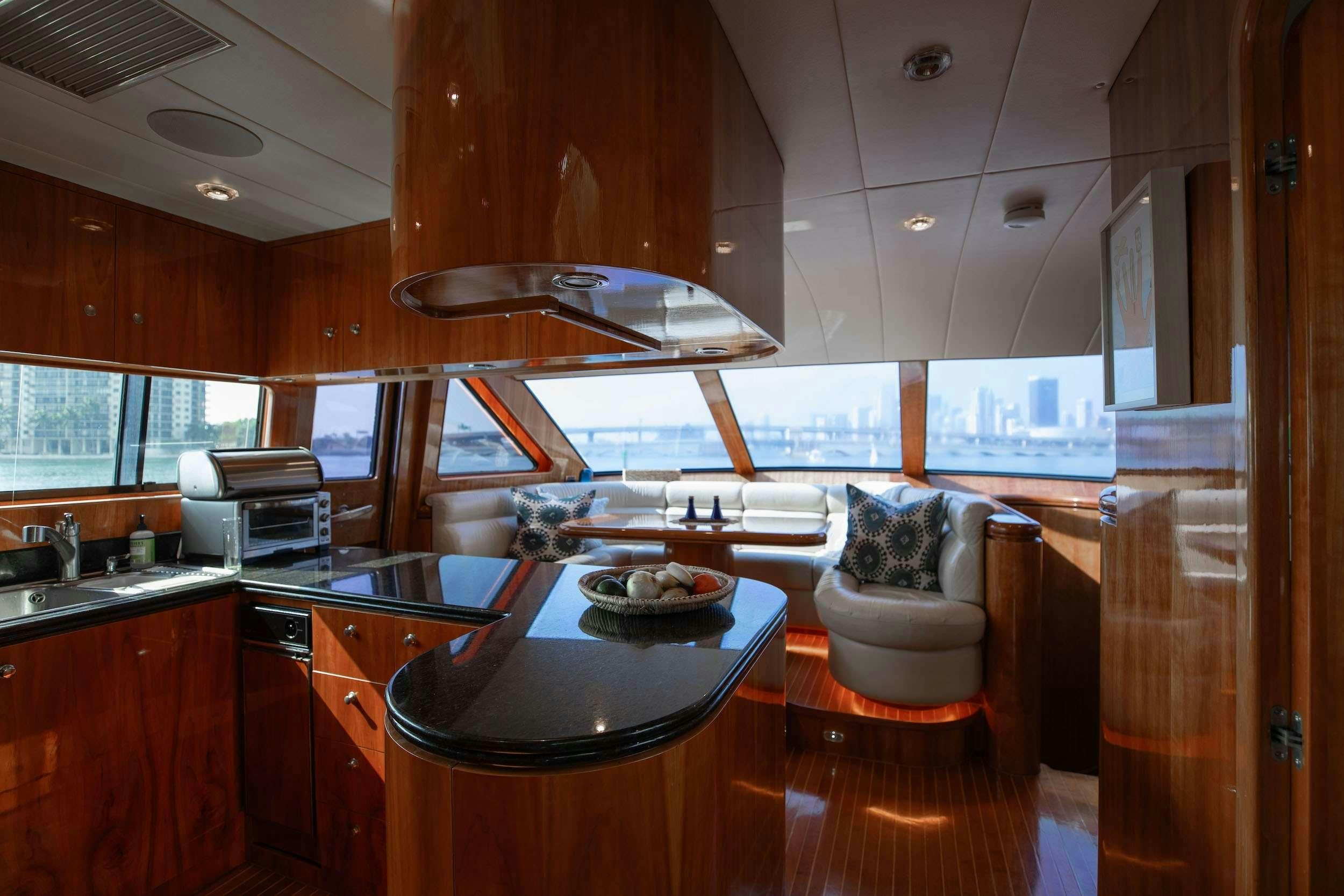 a kitchen with a table and chairs aboard THE USUAL Yacht for Charter