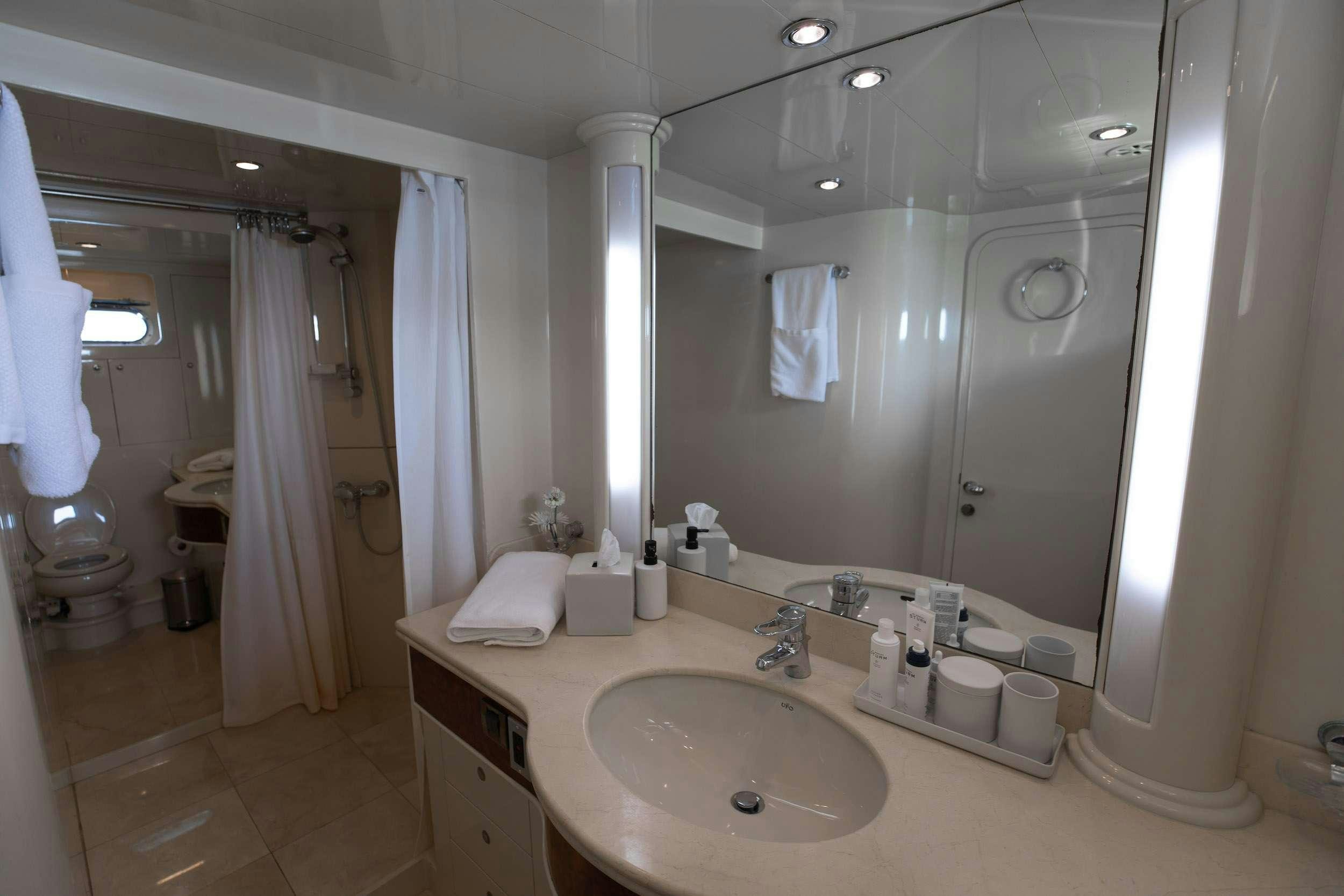 a bathroom with a large mirror aboard THE USUAL Yacht for Charter