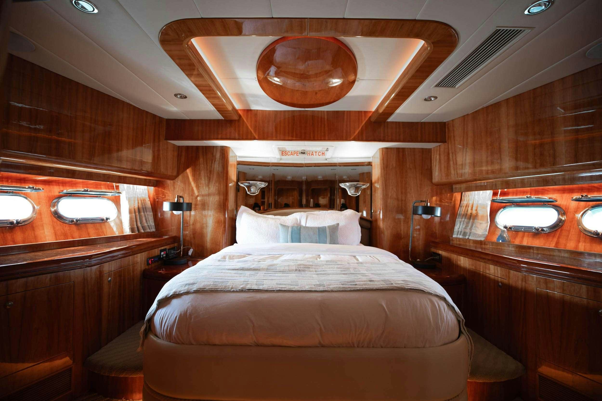 a room with a bed and a table aboard THE USUAL Yacht for Charter