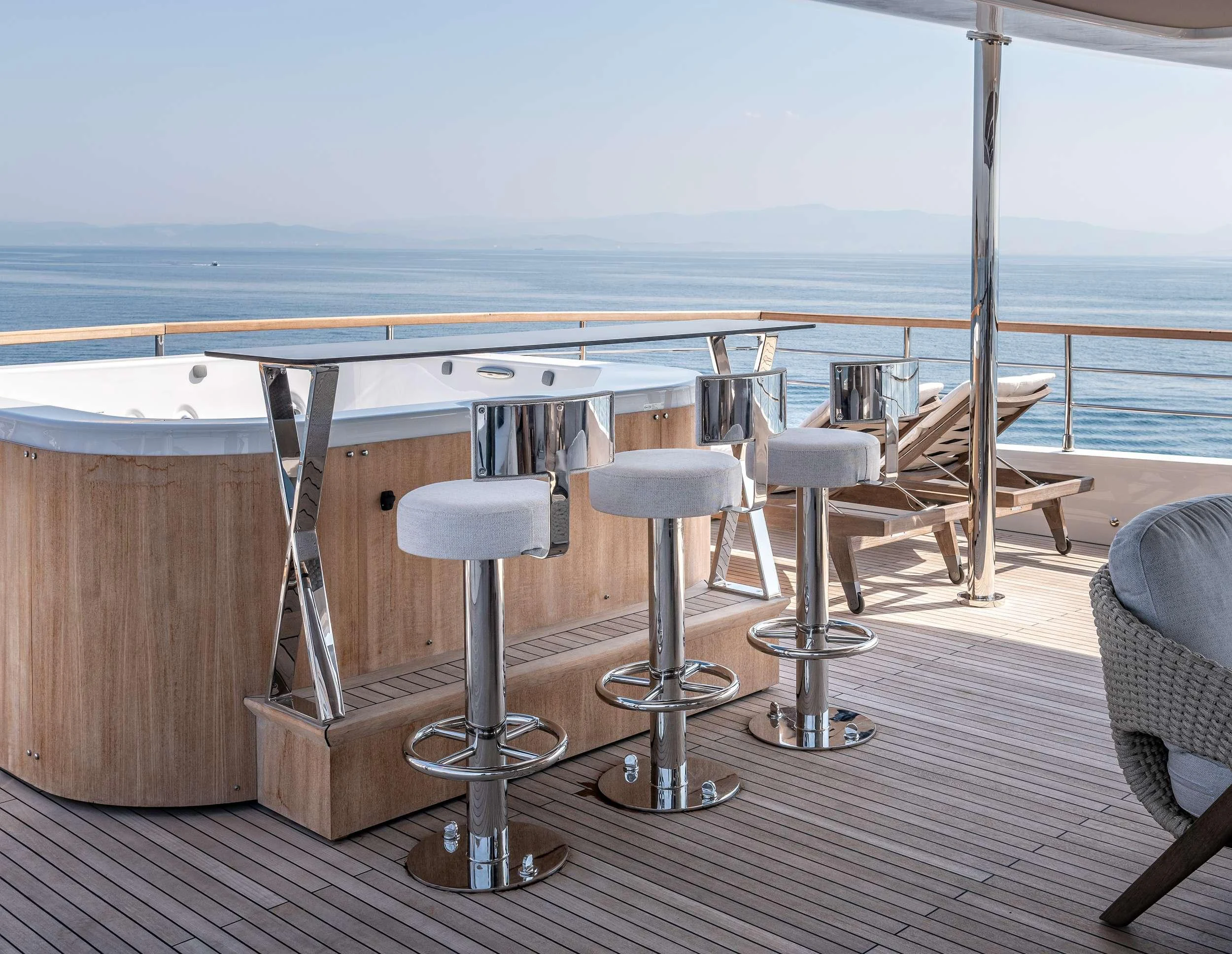 a room with a table chairs and a large body of water aboard EAU LA LA Yacht for Charter
