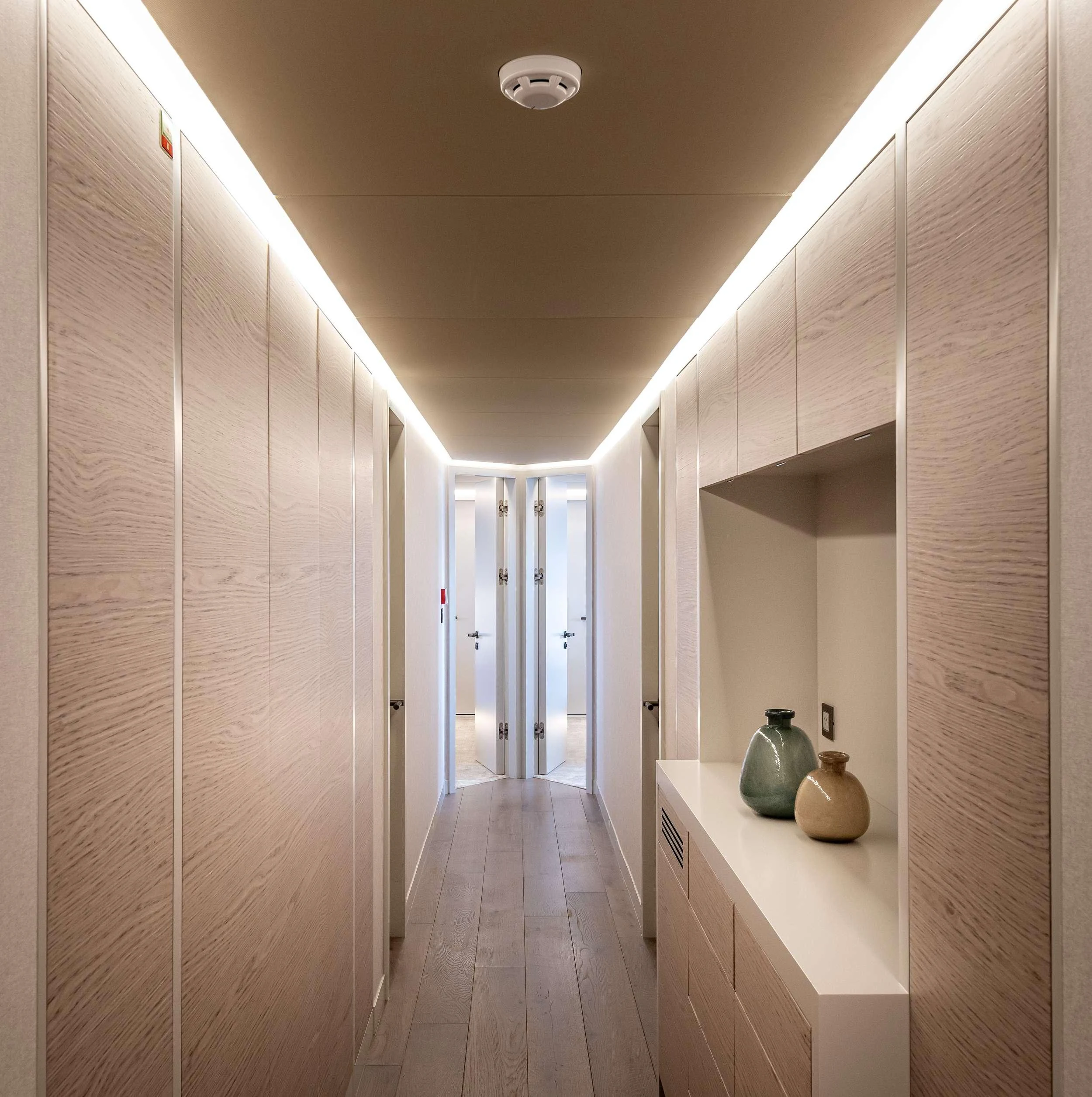 a hallway with white walls aboard EAU LA LA Yacht for Charter