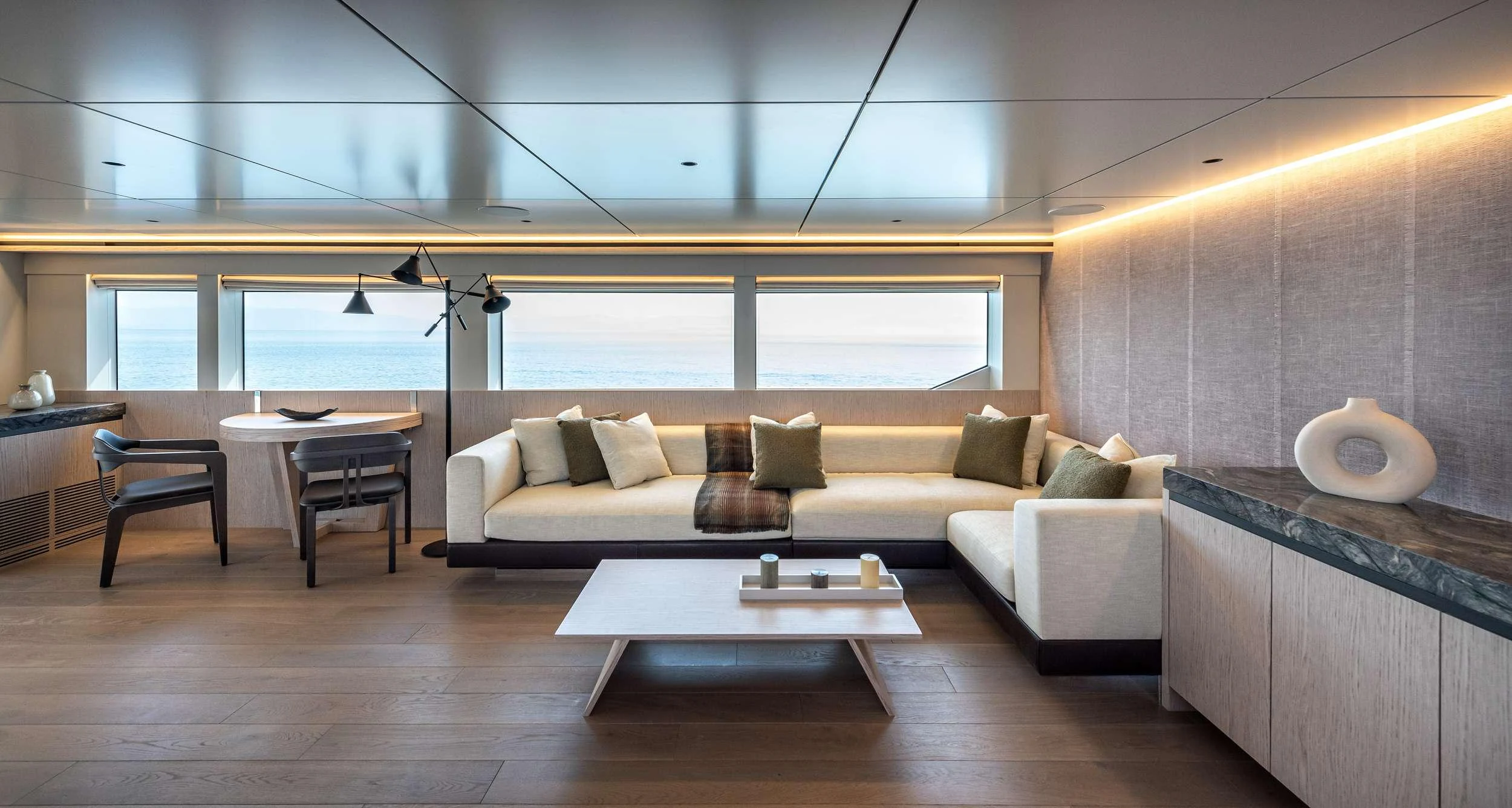 a living room with a couch and a table aboard EAU LA LA Yacht for Charter