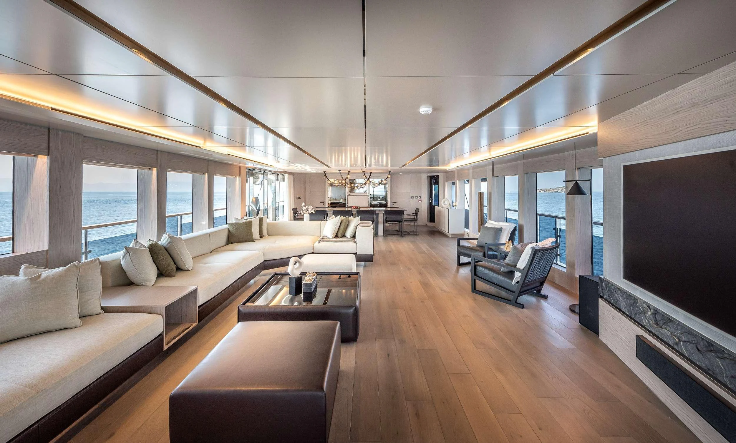 a living room with a large screen aboard EAU LA LA Yacht for Charter