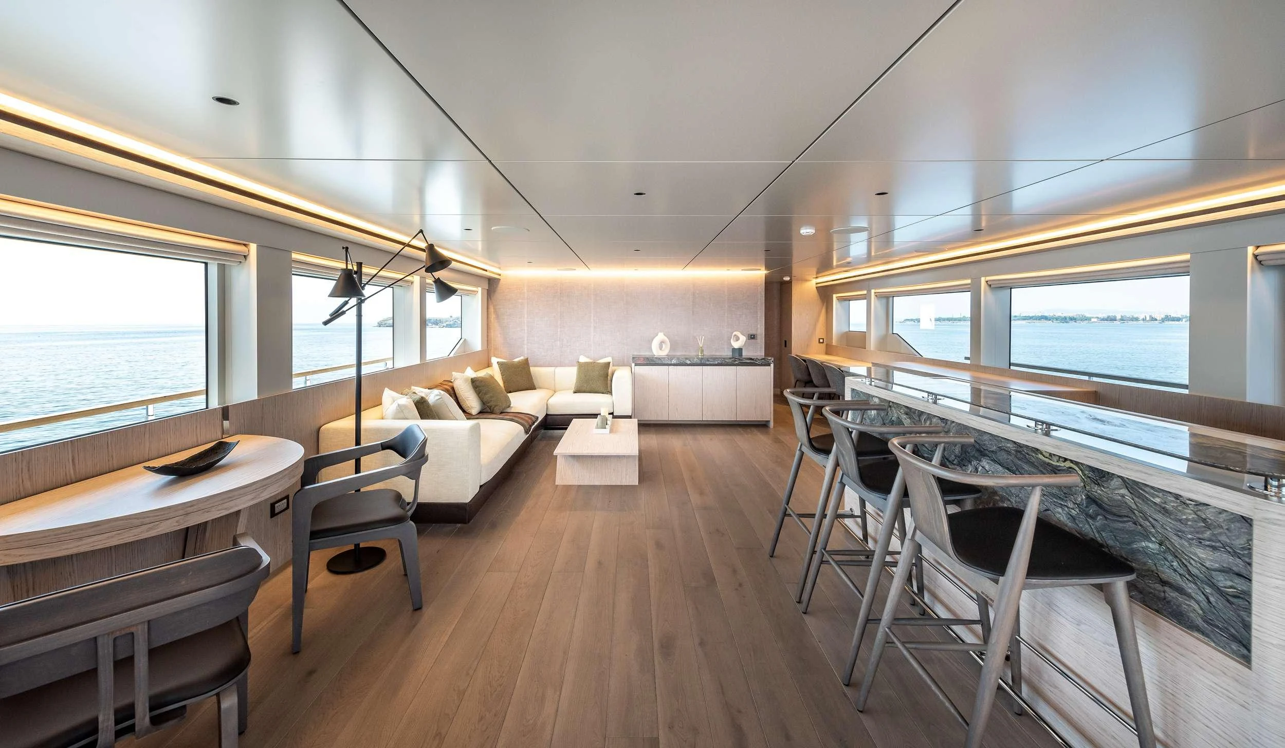 a living room with a wood floor aboard EAU LA LA Yacht for Charter