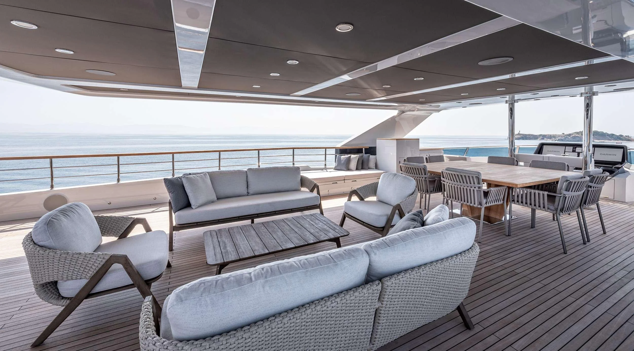 a room with couches and a table and chairs aboard EAU LA LA Yacht for Charter