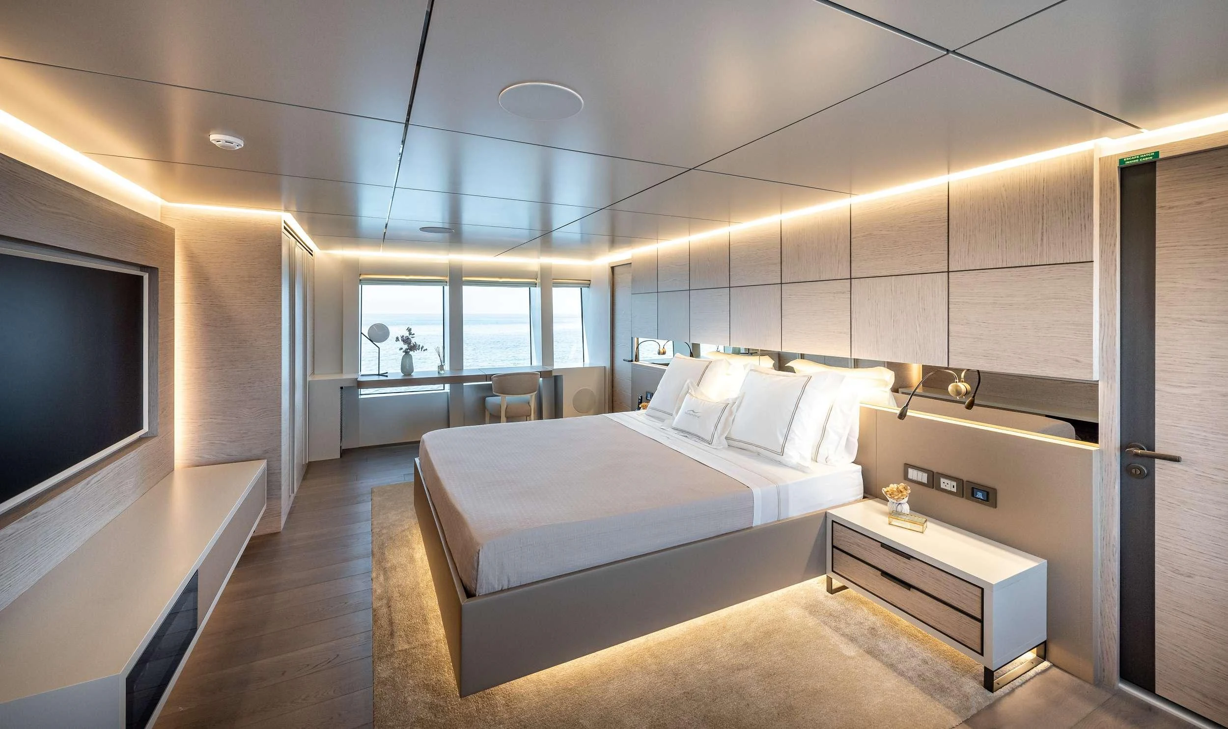 a room with a bed and a tv aboard EAU LA LA Yacht for Charter