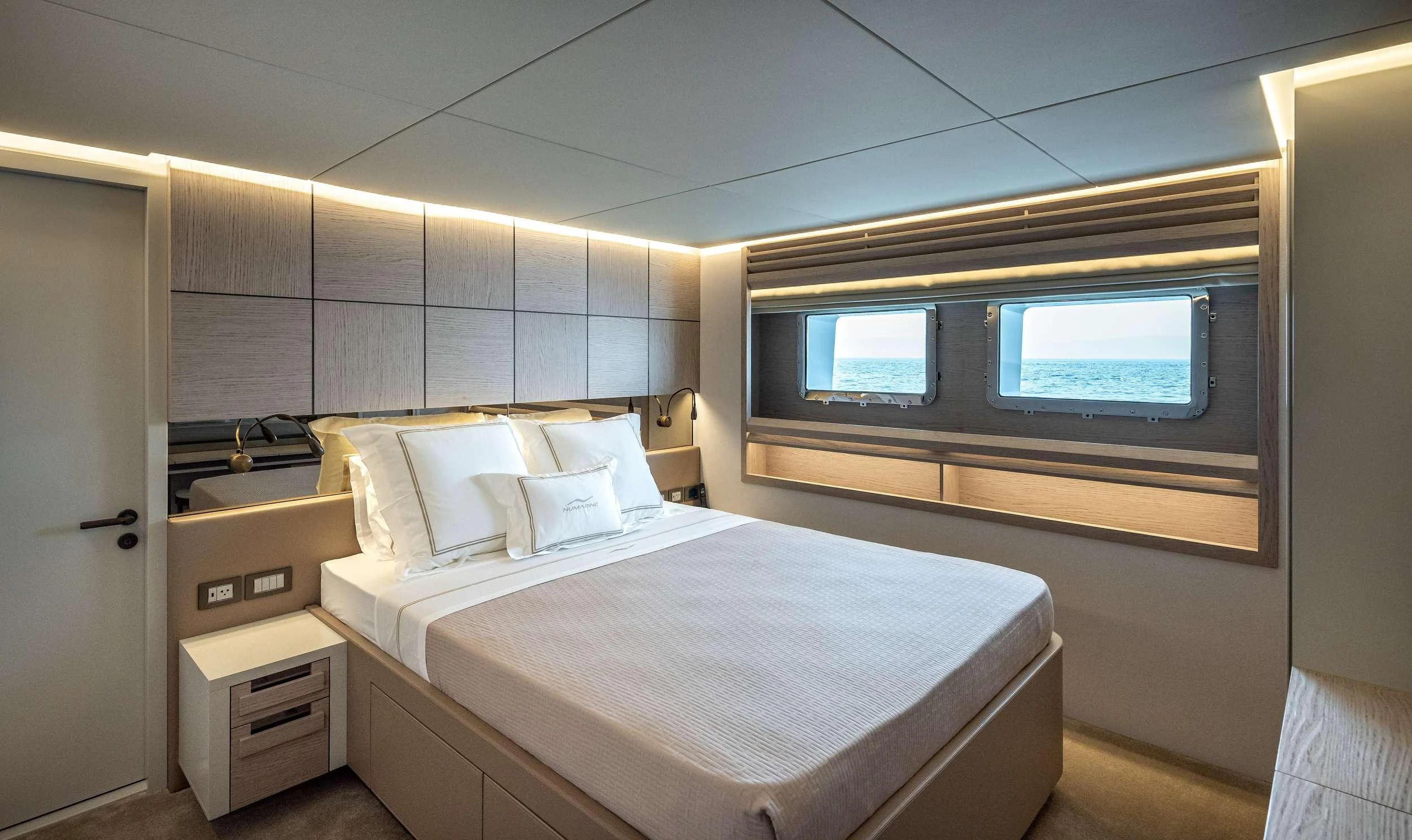 a room with a bed and a window aboard EAU LA LA Yacht for Charter