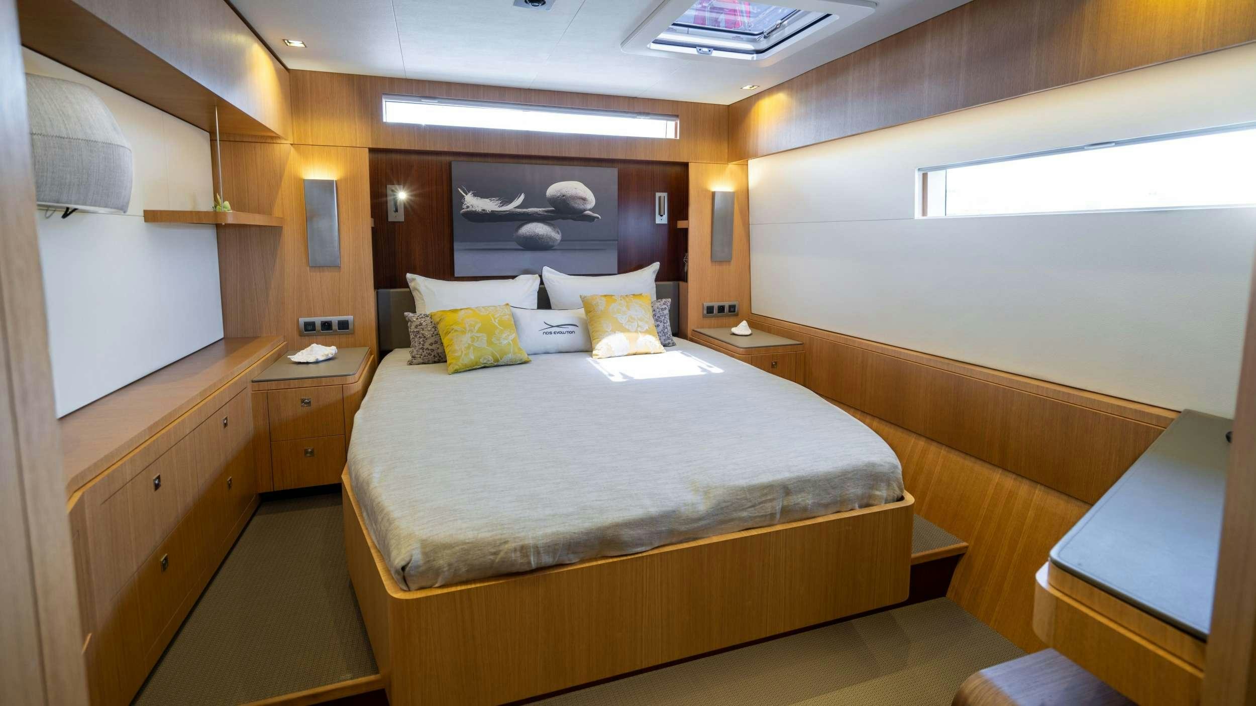 a room with a bed and a desk aboard NDS EVOLUTION Yacht for Charter
