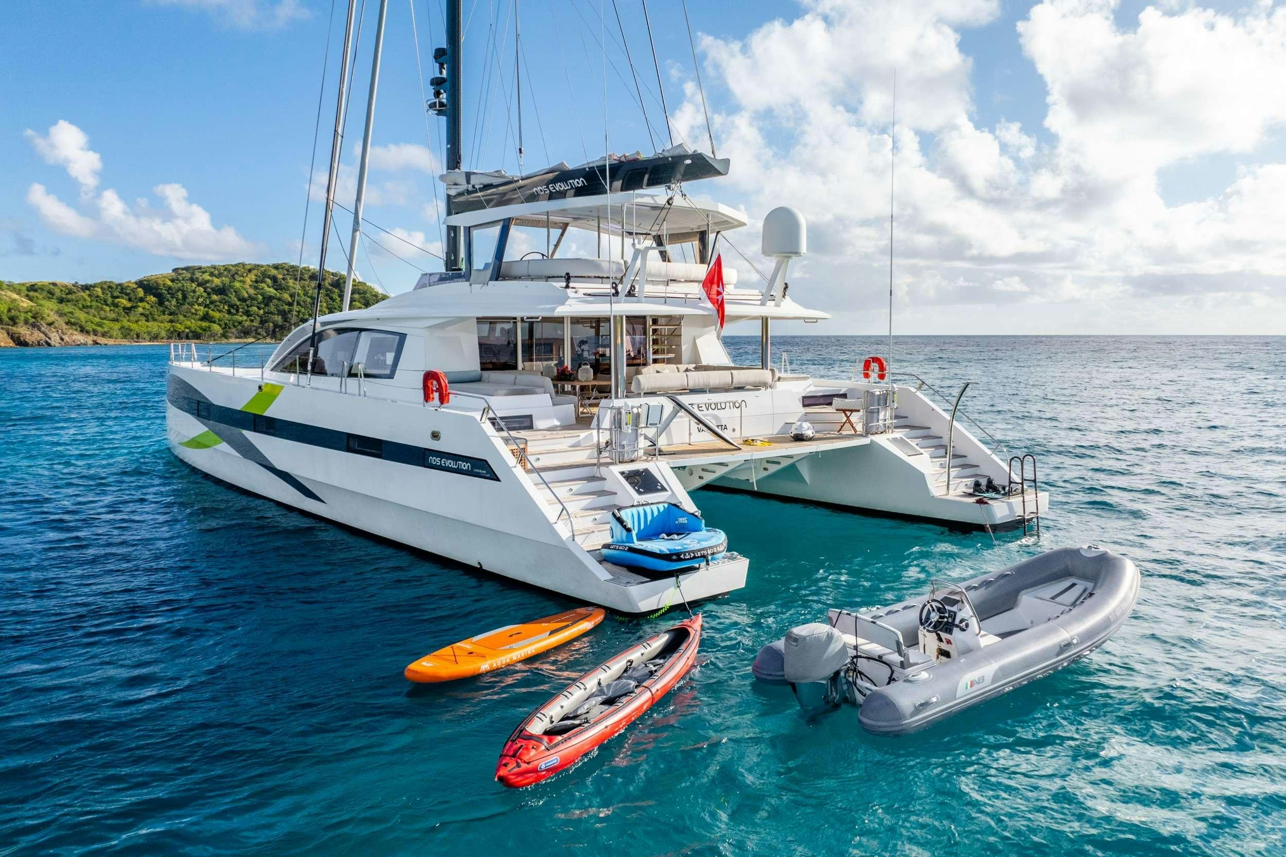 a boat and a motor boat in the water aboard NDS EVOLUTION Yacht for Charter