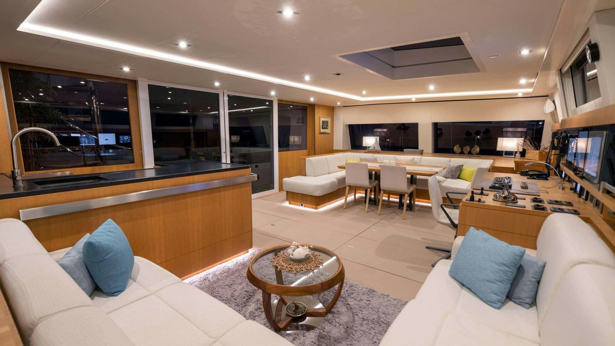 a living room with a large window aboard NDS EVOLUTION Yacht for Charter