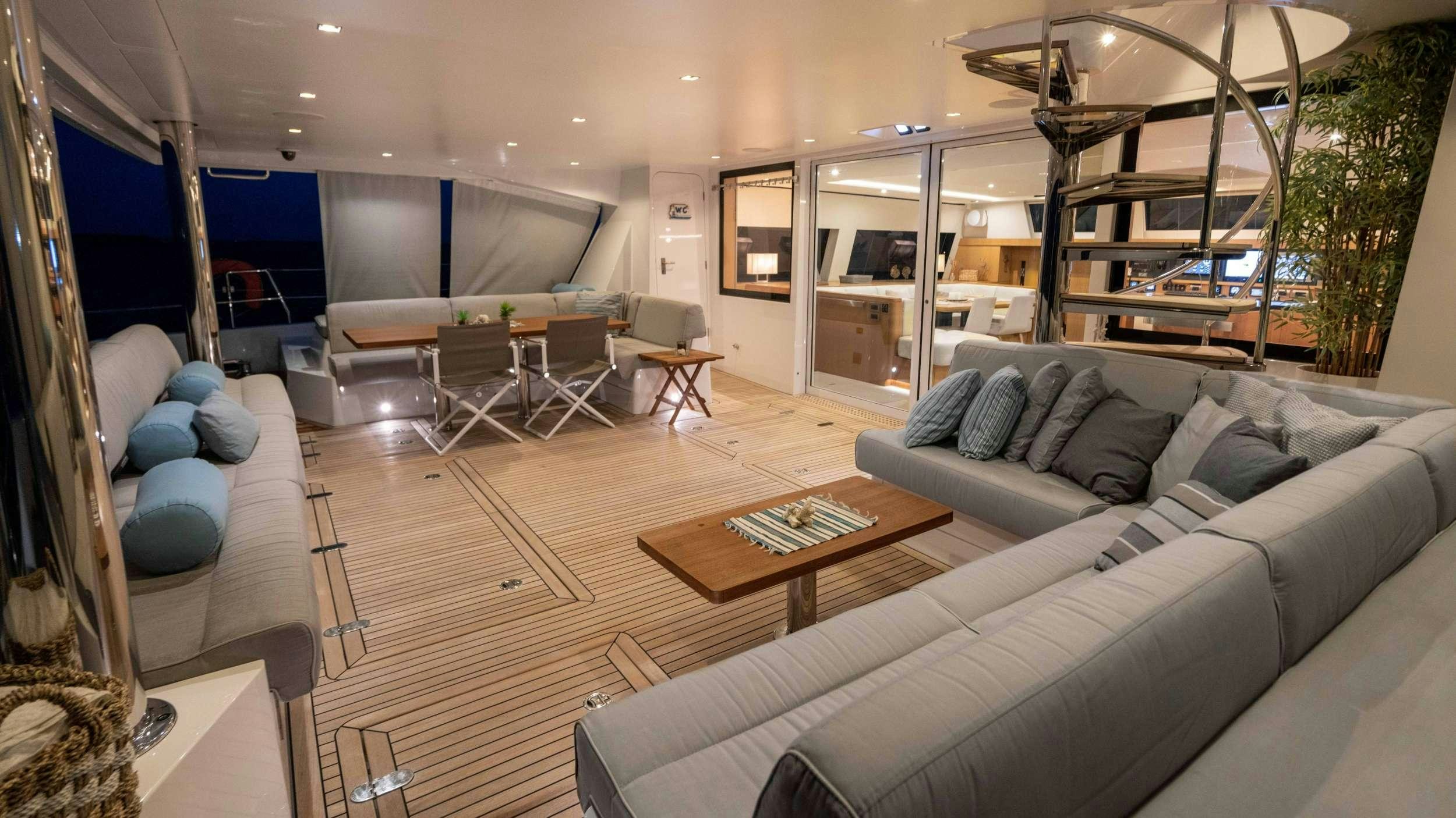a living room with a couch and a table aboard NDS EVOLUTION Yacht for Charter
