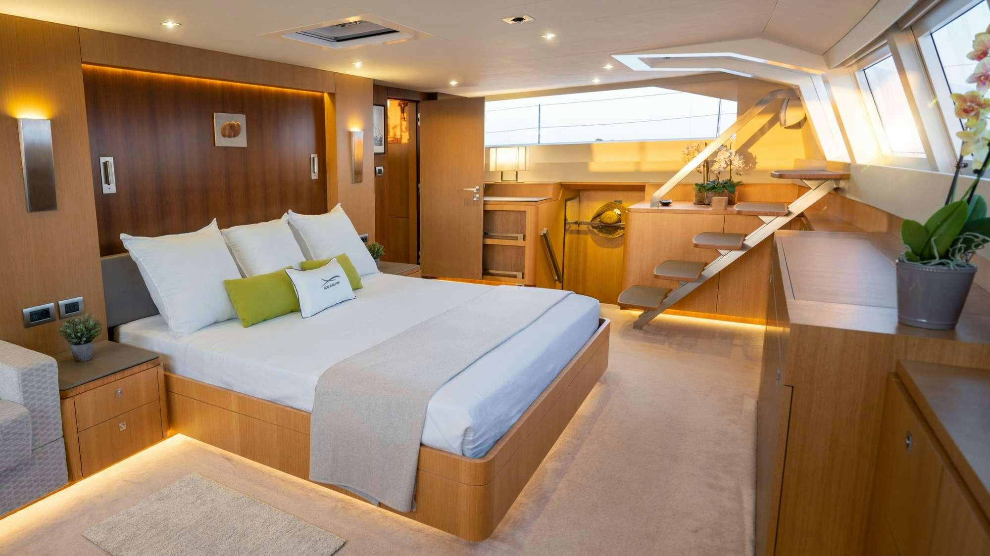 a hotel room with a bed and desk aboard NDS EVOLUTION Yacht for Charter