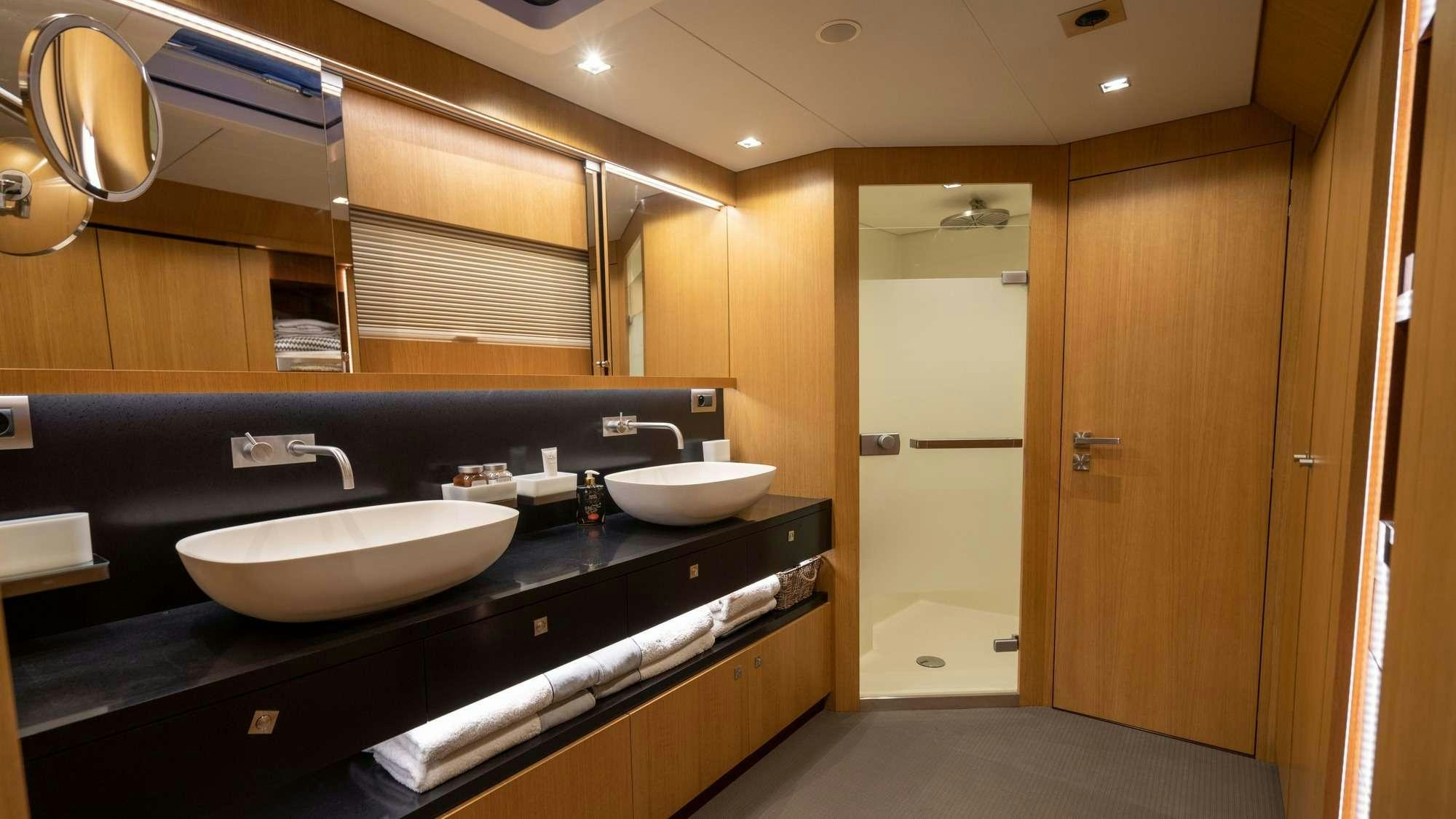 a bathroom with sinks and mirrors aboard NDS EVOLUTION Yacht for Charter