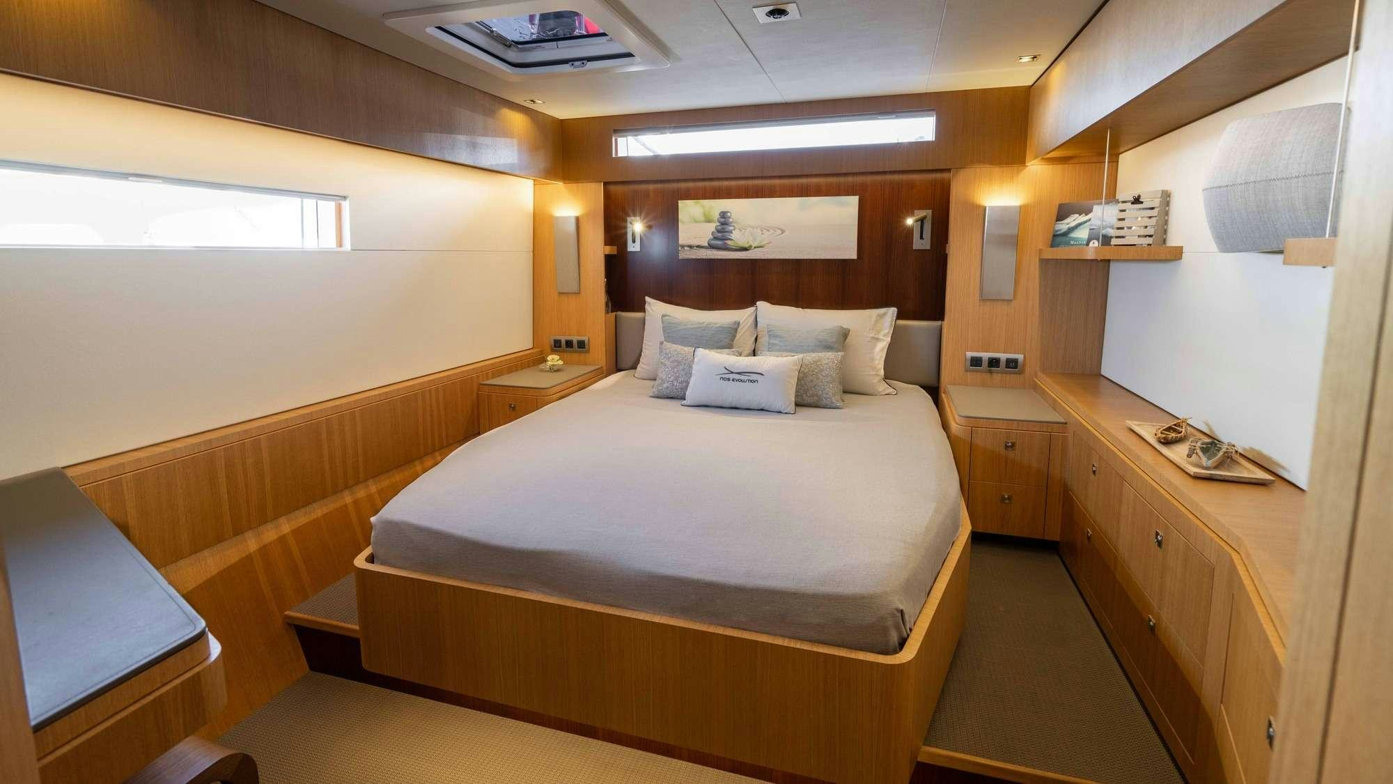 a room with a bed and a desk aboard NDS EVOLUTION Yacht for Charter