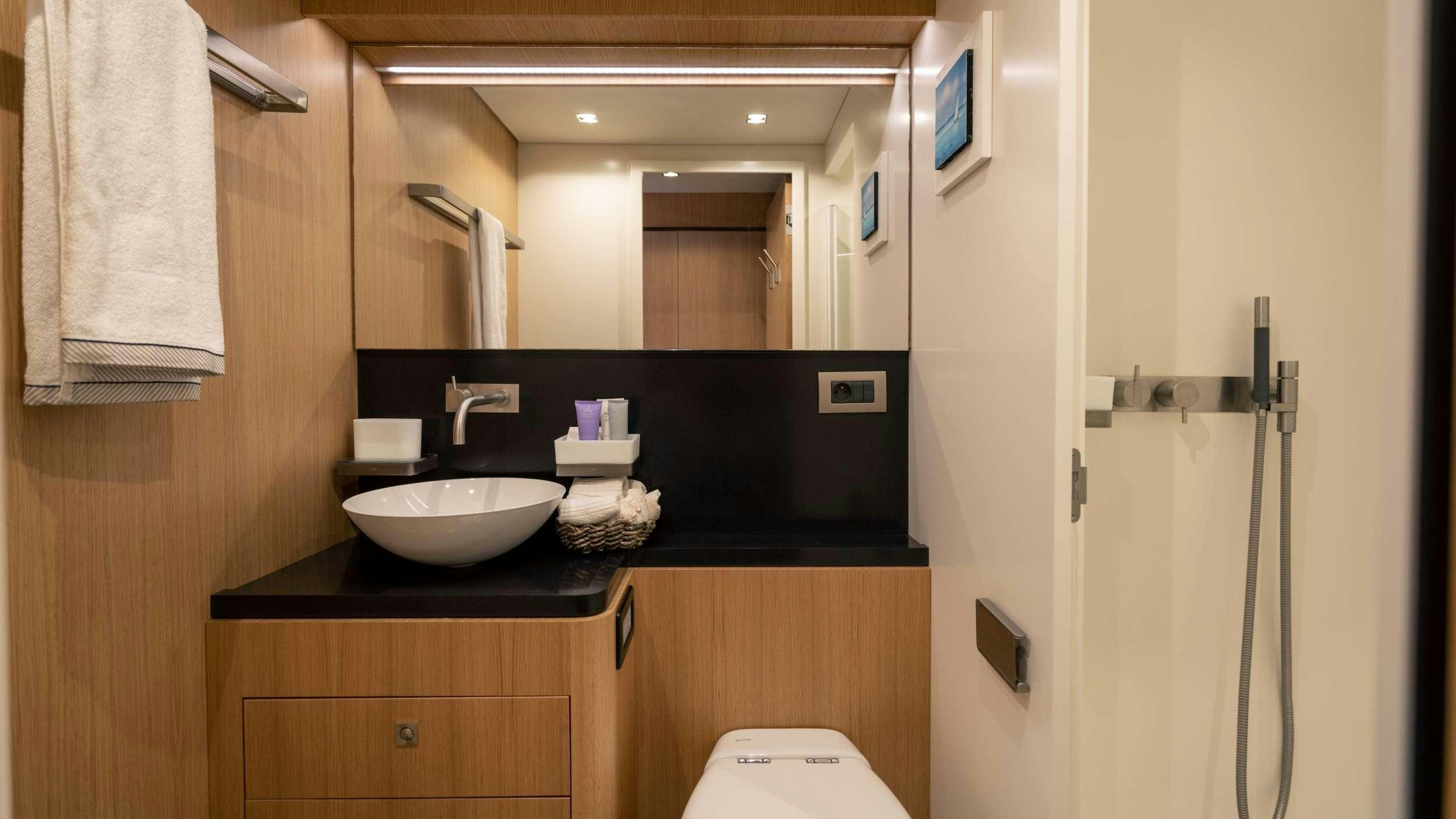 a bathroom with a sink and a mirror aboard NDS EVOLUTION Yacht for Charter
