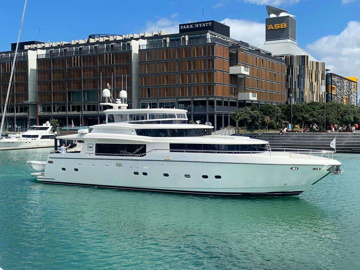 a large white boat in a harbor aboard WW Yacht for Charter