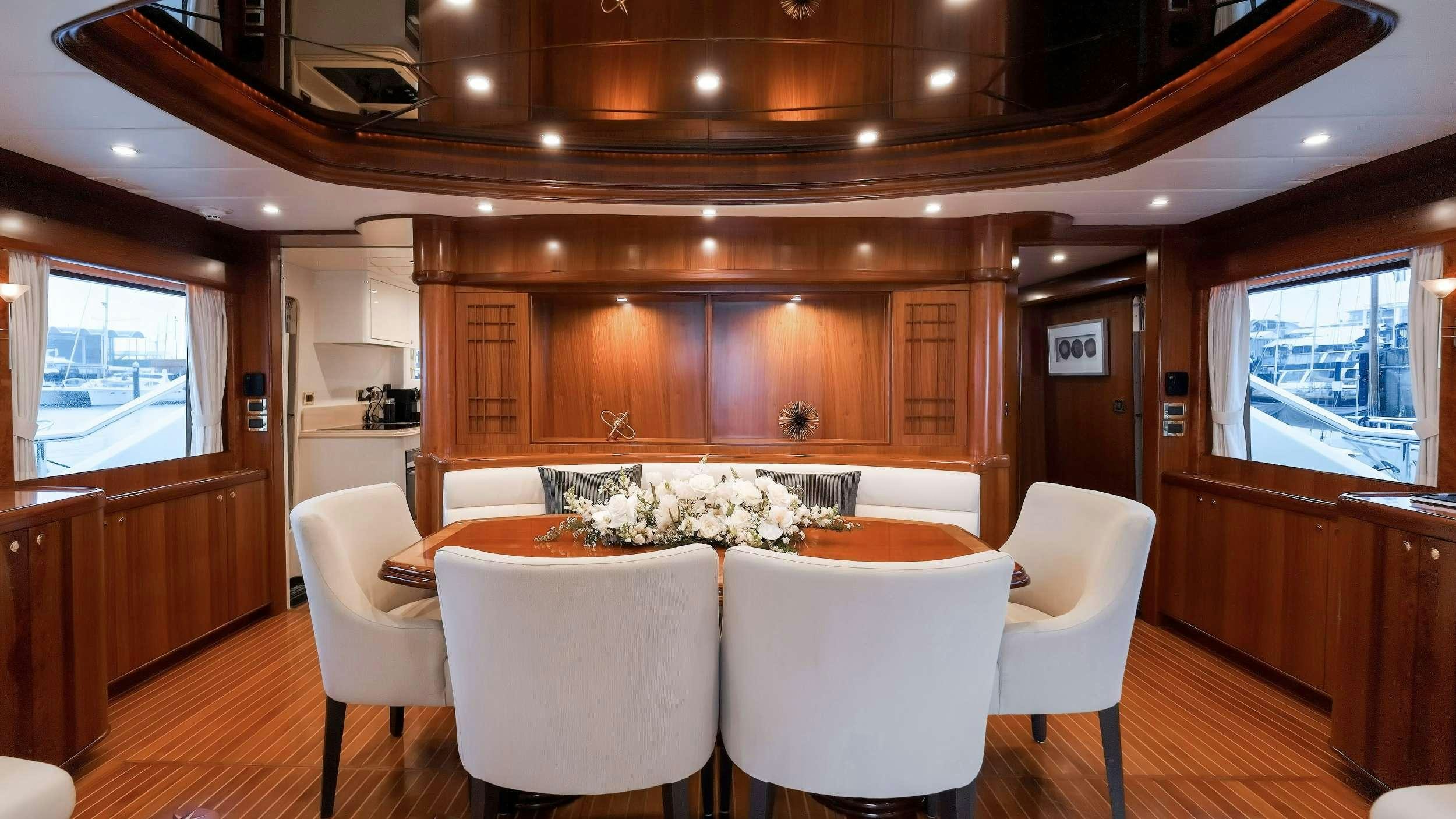 a room with a table and chairs aboard WW Yacht for Charter