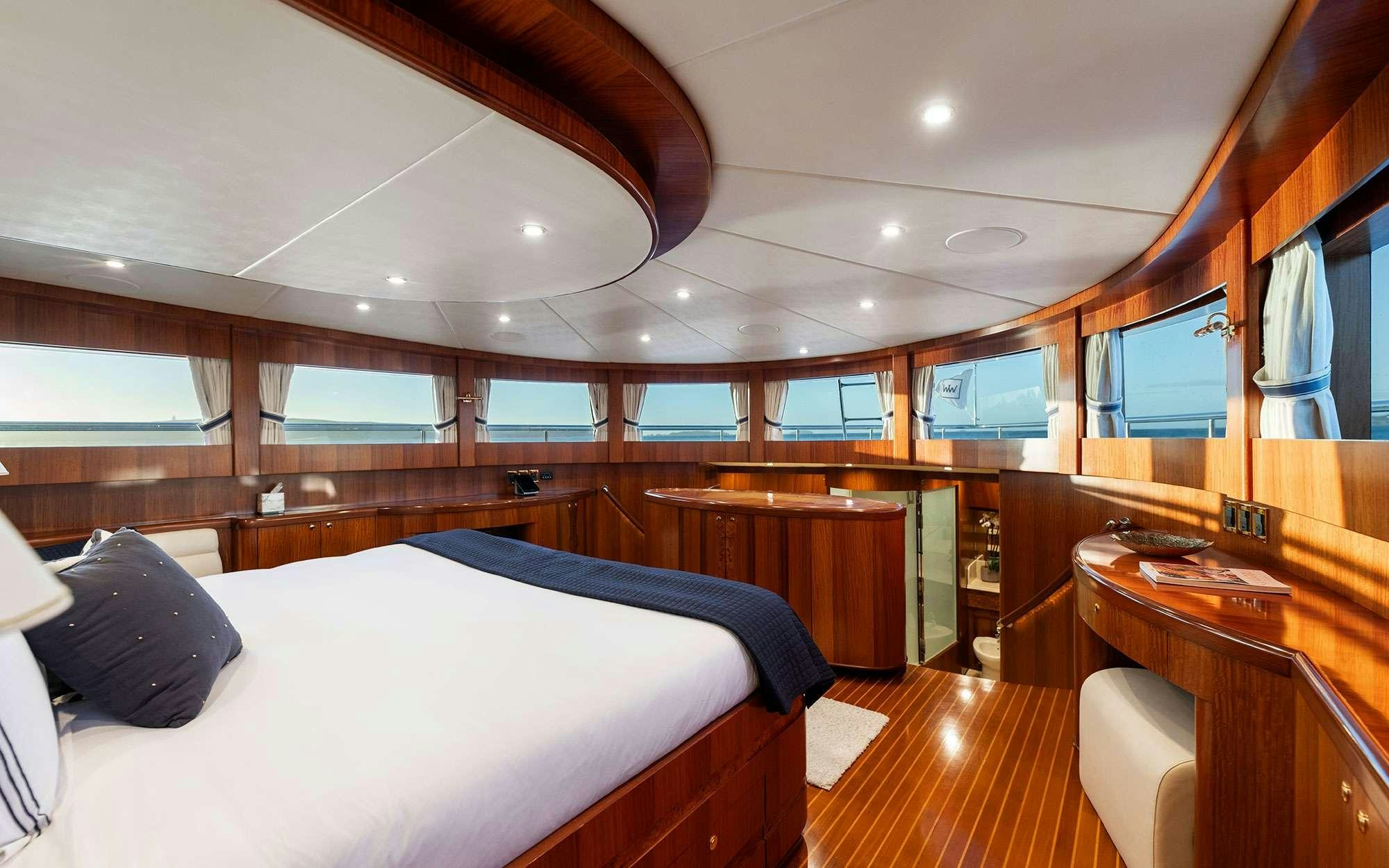 a room with a bed and desk aboard WW Yacht for Charter
