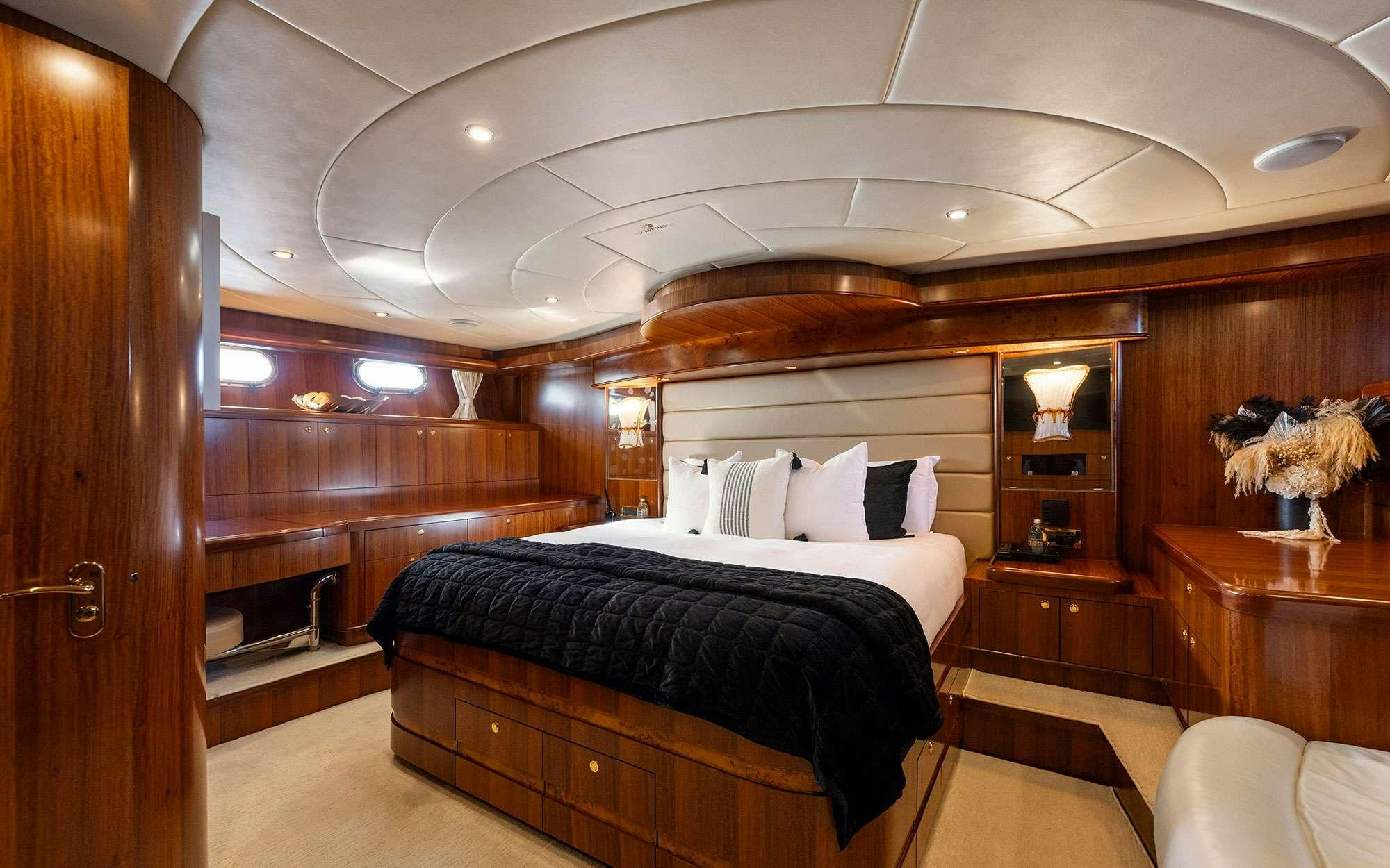 a room with a bed and a wood cabinet aboard WW Yacht for Charter