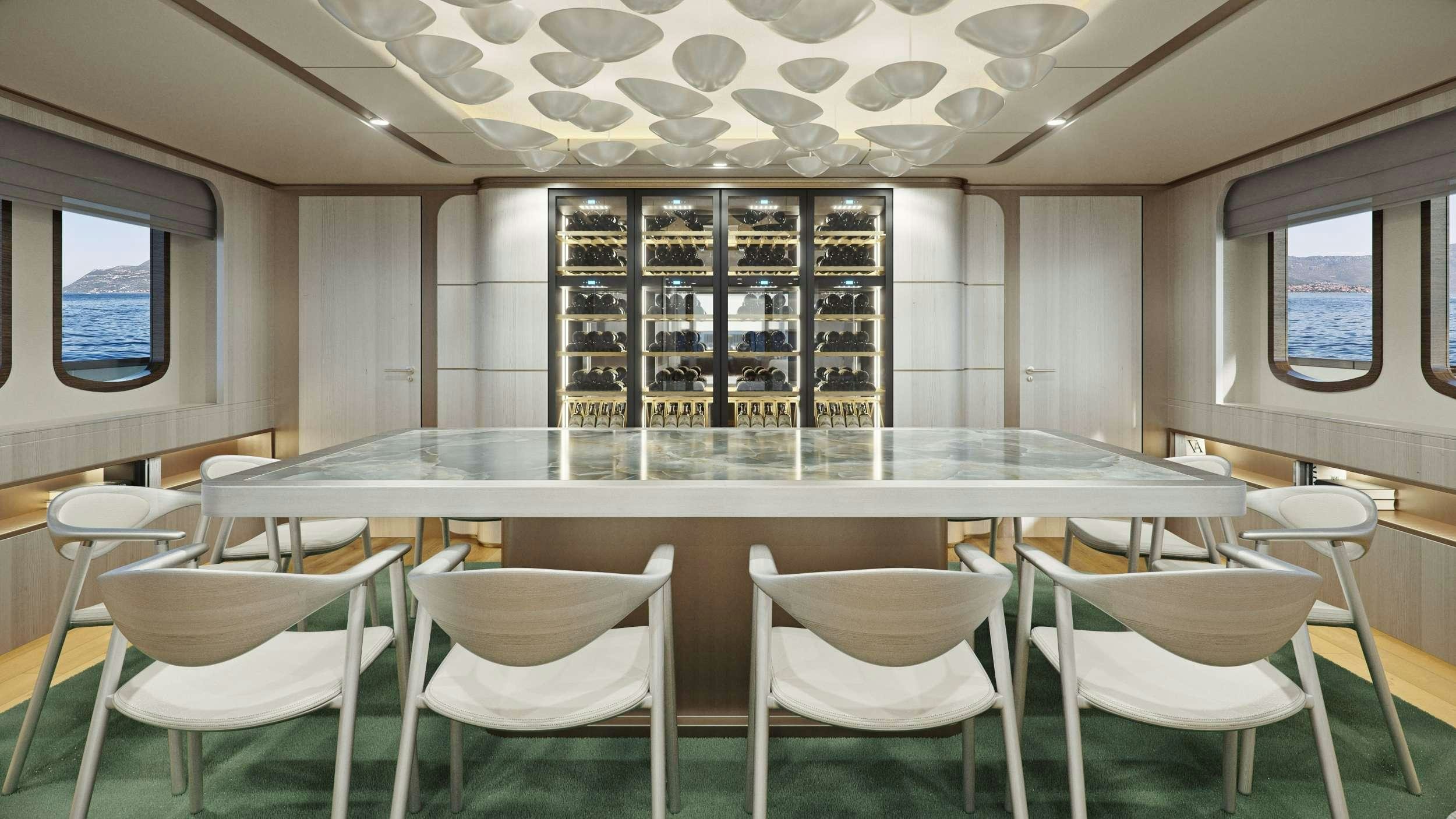 a room with tables and chairs aboard MAIA Yacht for Charter