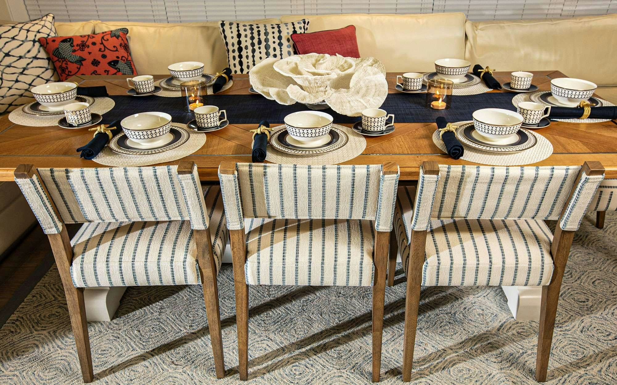 a table with chairs and plates on it aboard BUNDALONG Yacht for Charter