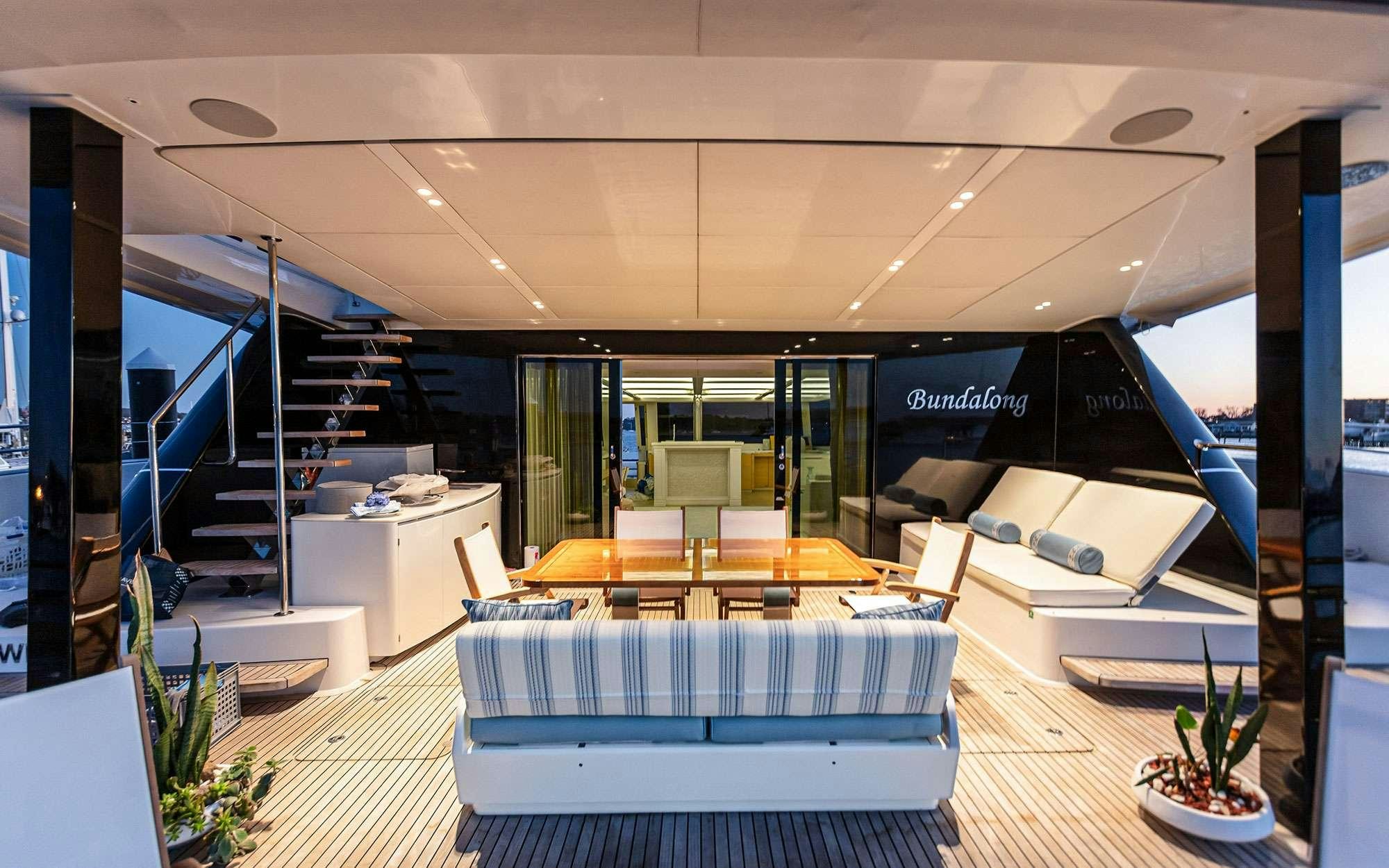 a room with a large white table and chairs aboard BUNDALONG Yacht for Charter