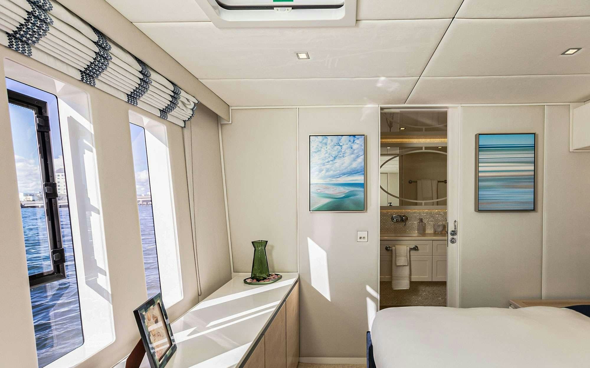 a room with a bed and a sink aboard BUNDALONG Yacht for Charter