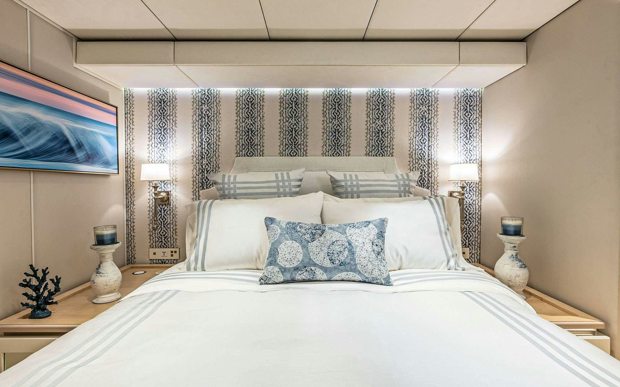 a bed with a white bed spread aboard BUNDALONG Yacht for Charter
