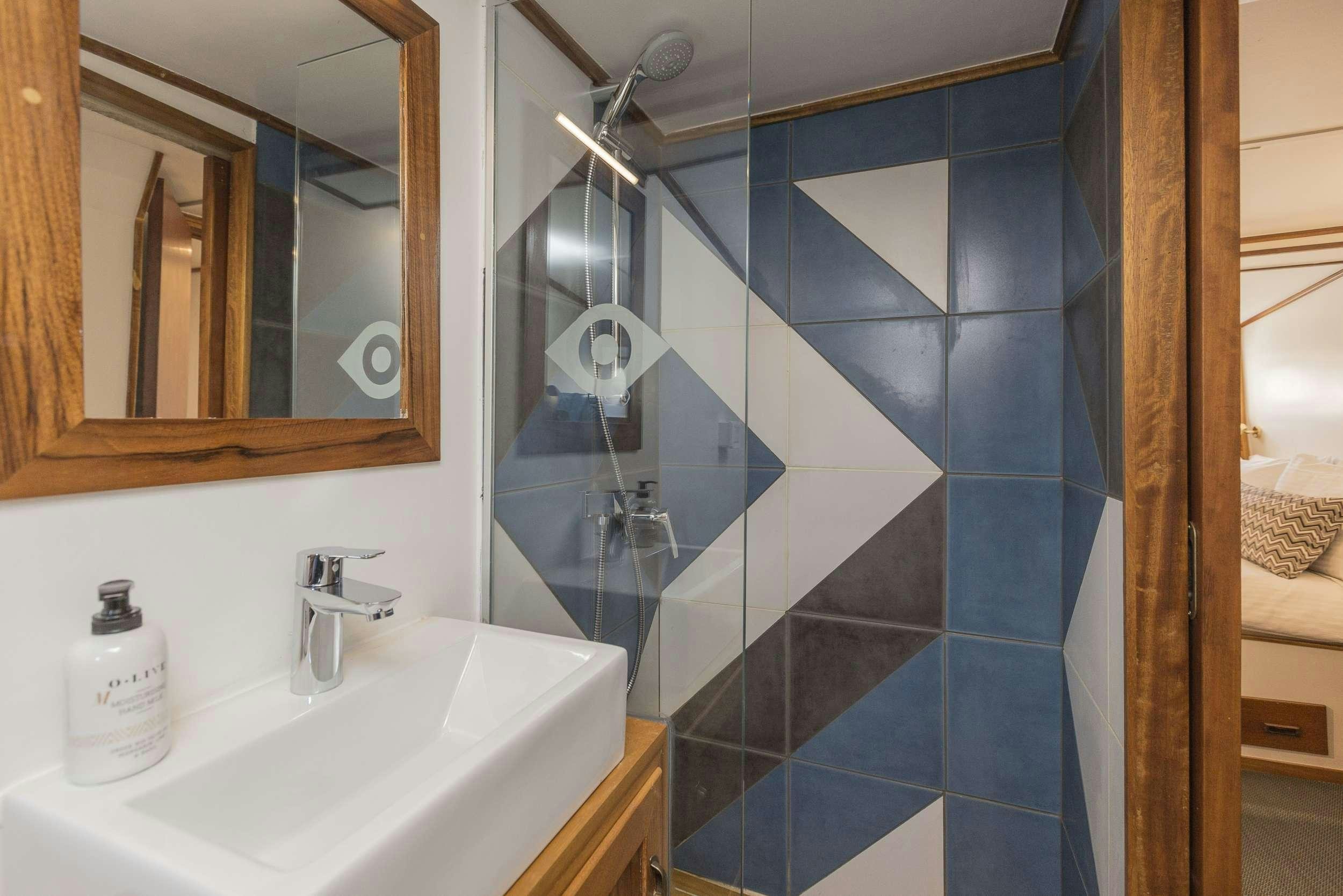 a bathroom with a large mirror aboard COSMOS Yacht for Charter