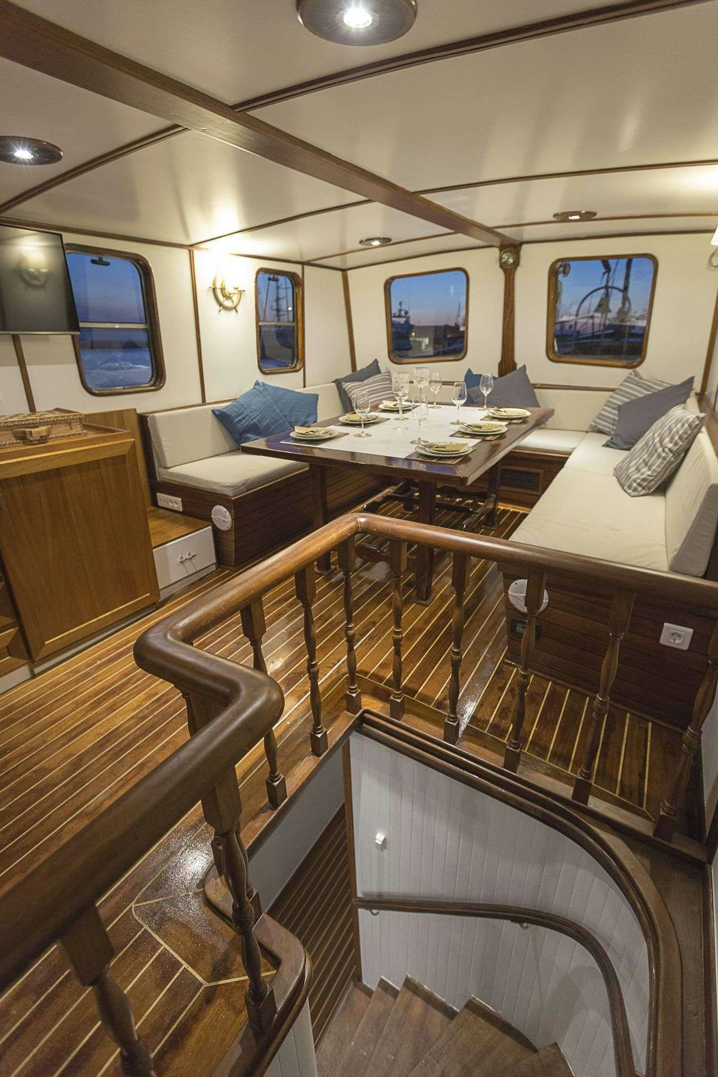 a room with a desk and chairs aboard COSMOS Yacht for Charter