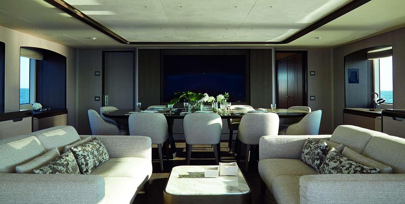 a living room with a table and couches aboard WATERCOLOURS Yacht for Charter