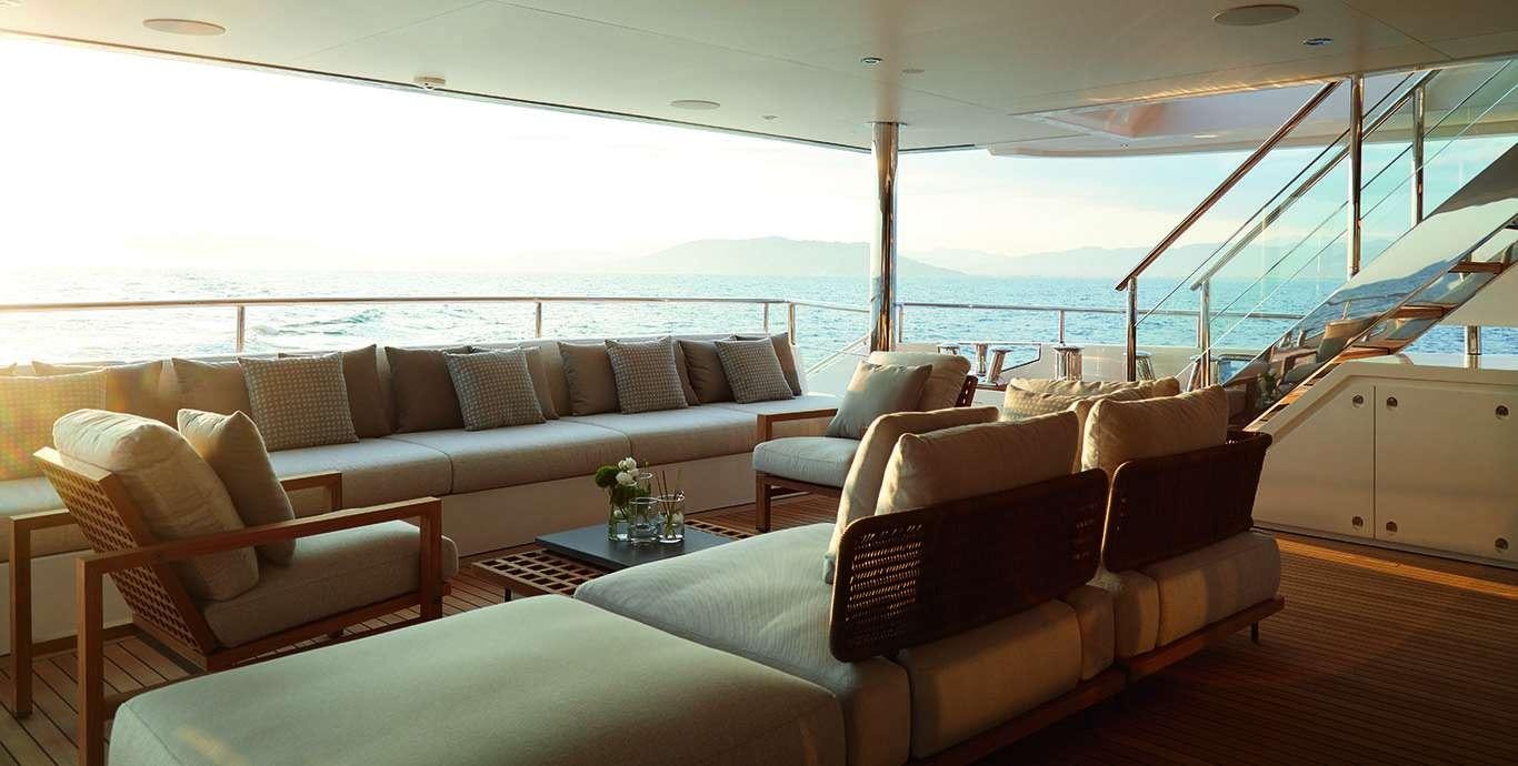 a living room with couches and a table aboard WATERCOLOURS Yacht for Charter