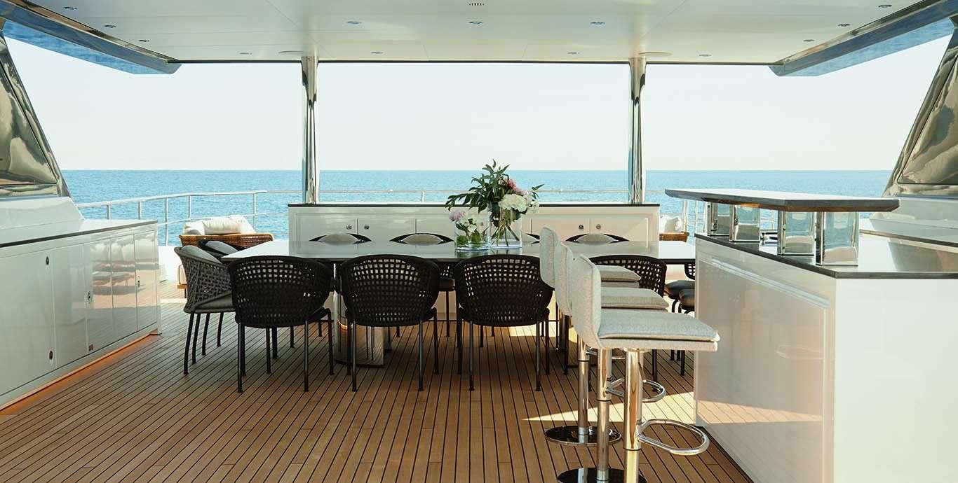 a large room with a table and chairs aboard WATERCOLOURS Yacht for Charter
