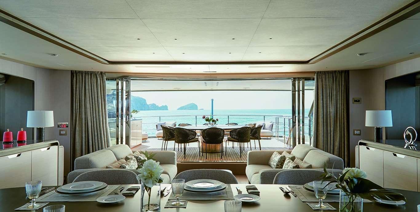 a living room with a large balcony aboard WATERCOLOURS Yacht for Charter