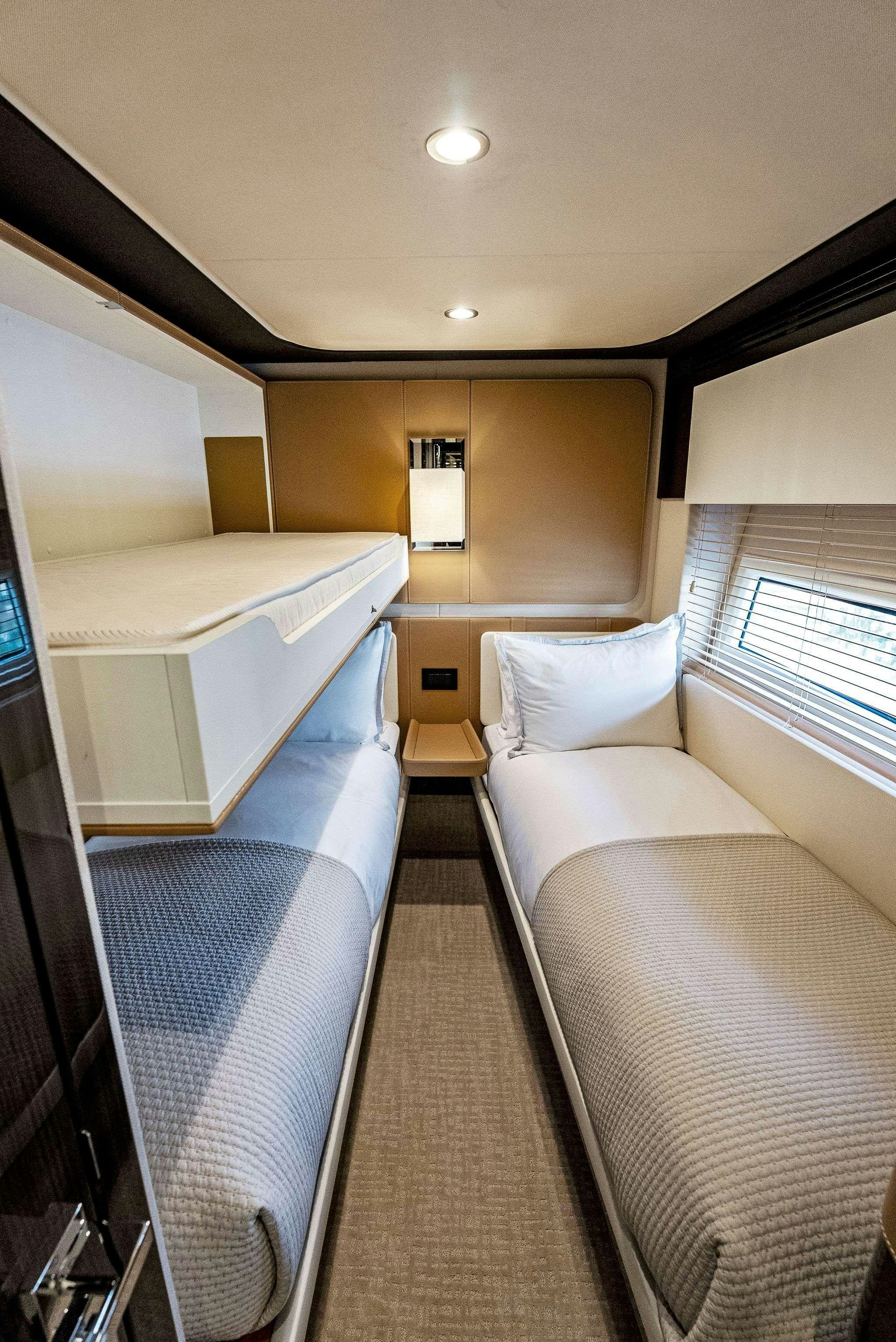 a room with a bed and a desk aboard FANTASTIC Yacht for Charter