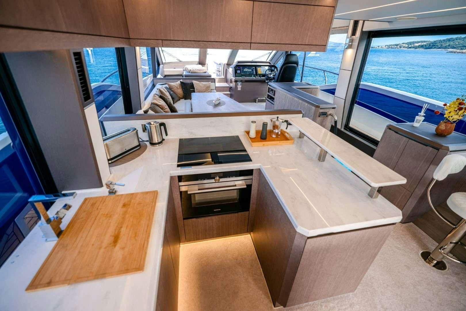 a room with a large window and a desk with a computer on it aboard FG STAR Yacht for Charter