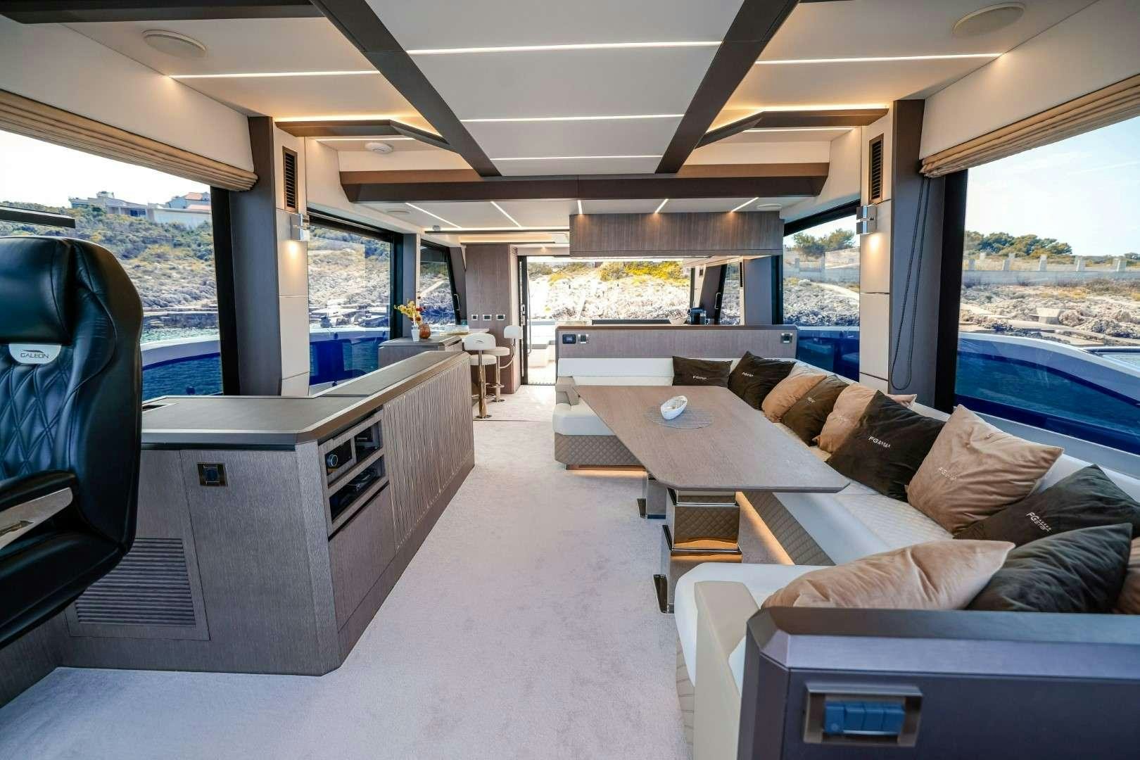 a living room with a large window aboard FG STAR Yacht for Charter