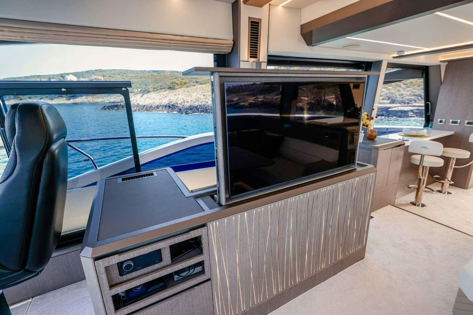 a room with a tv and a chair aboard FG STAR Yacht for Charter