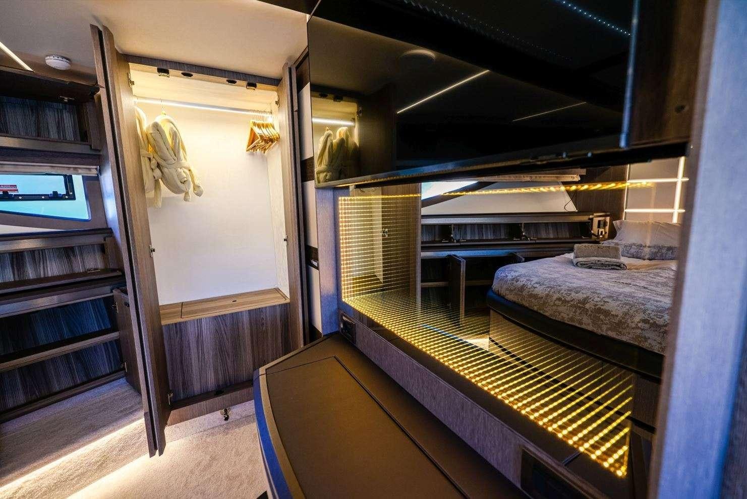 a room with a bed and a bookcase aboard FG STAR Yacht for Charter
