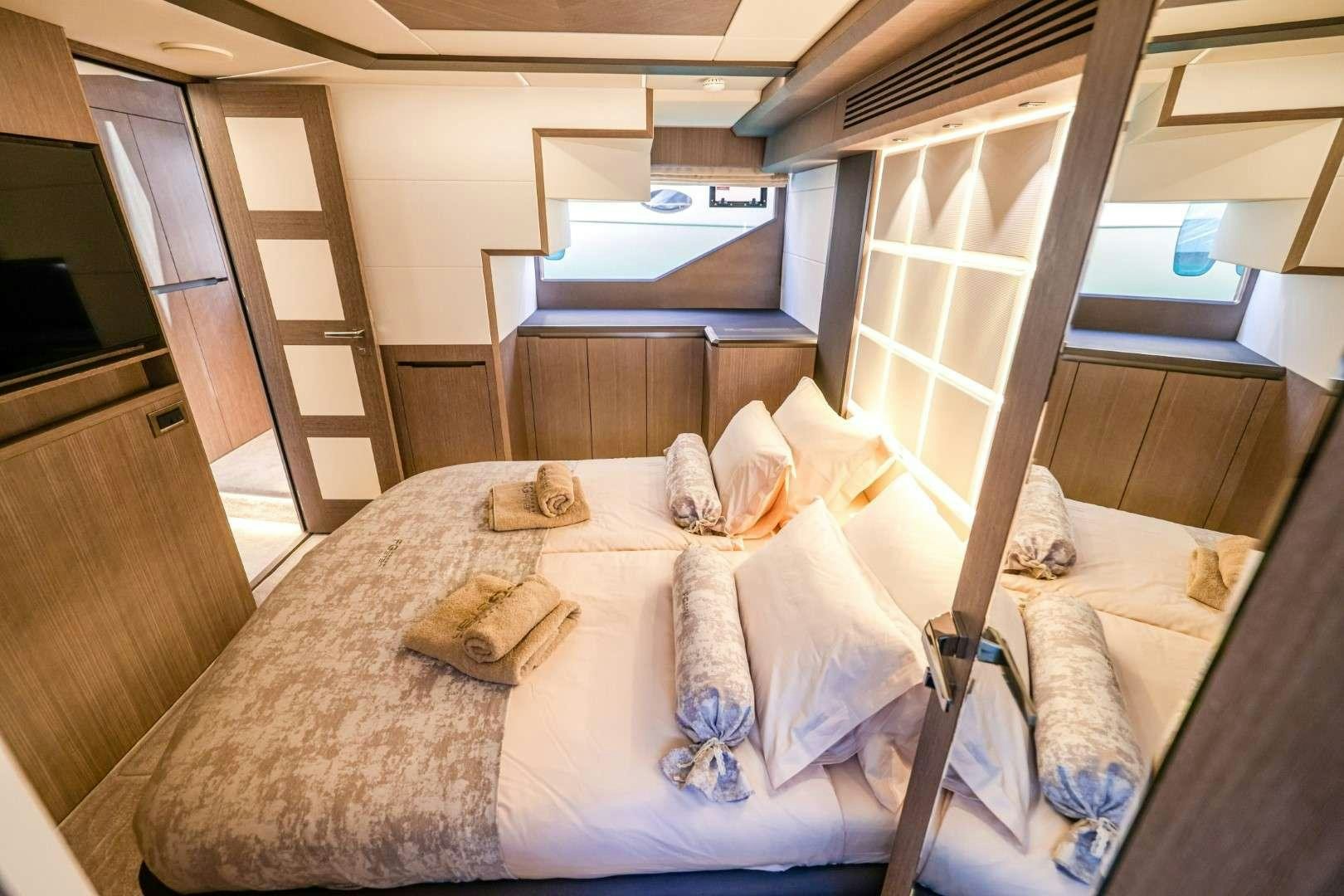 a bed with a white comforter aboard FG STAR Yacht for Charter