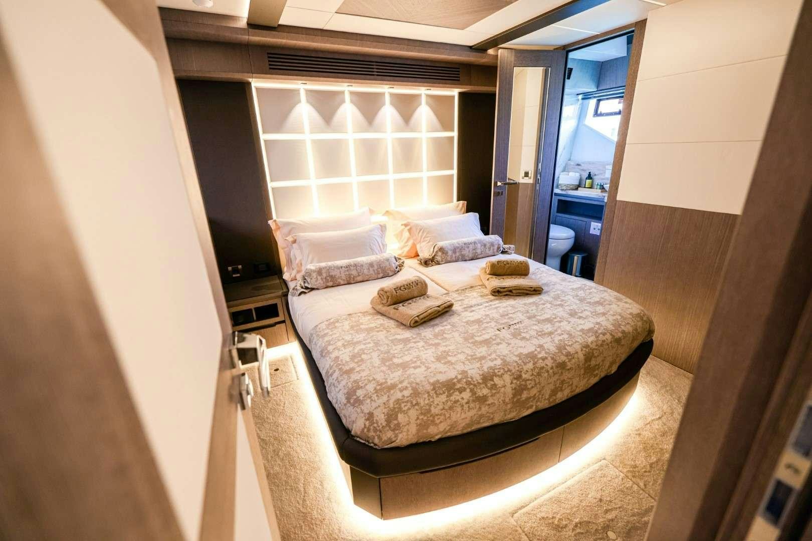 a bed with a white sheet aboard FG STAR Yacht for Charter