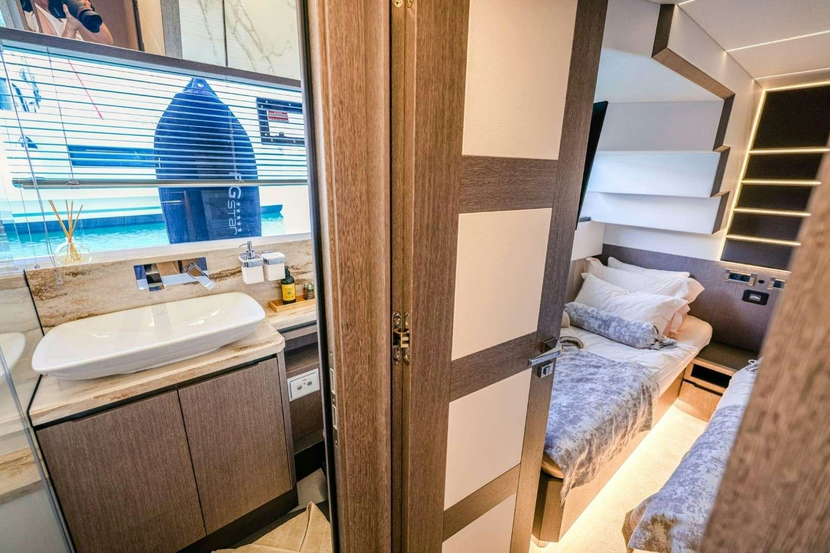 a small bedroom with a bed and a sink aboard FG STAR Yacht for Charter