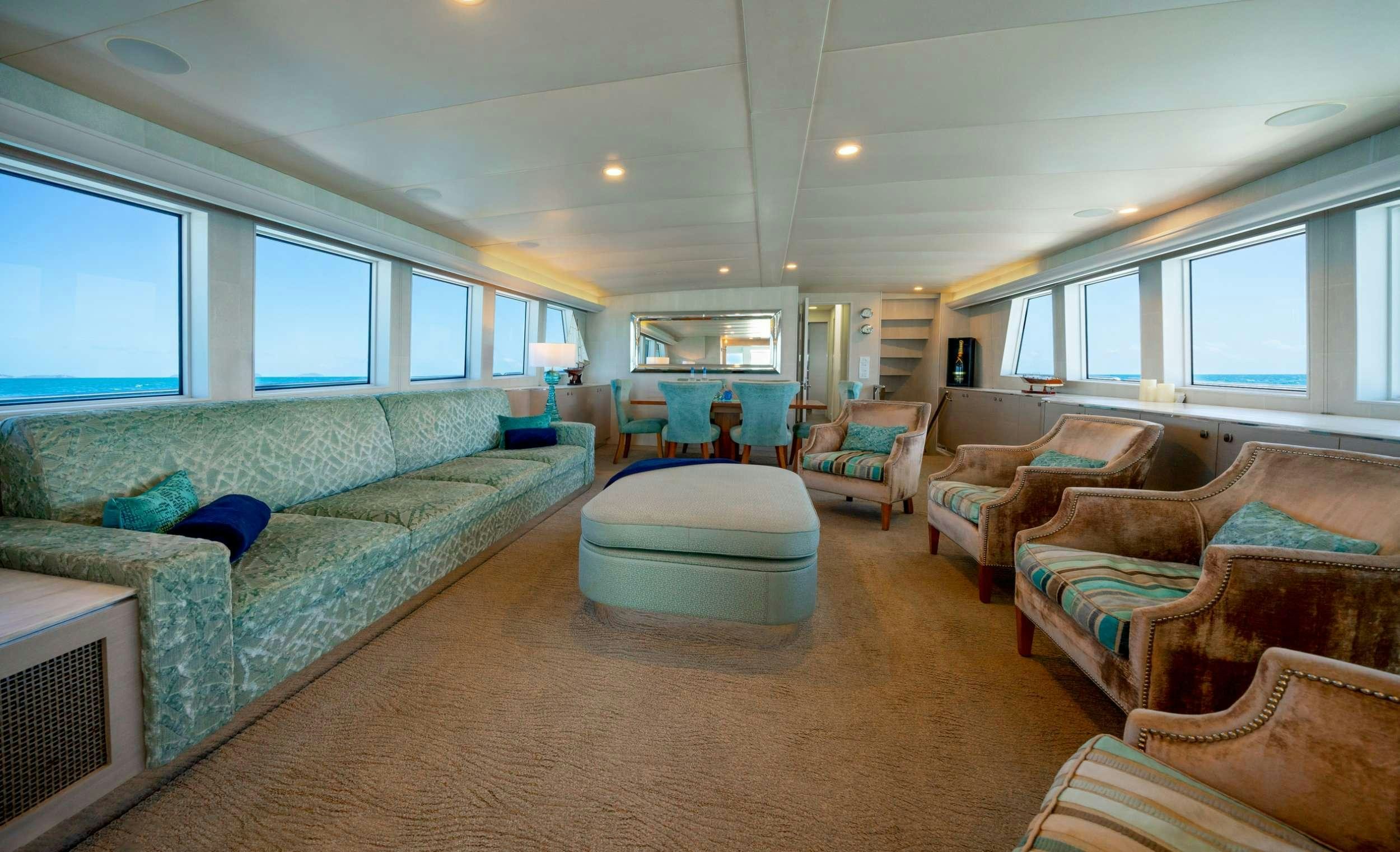 a living room with a couch and a table aboard SHORETHING Yacht for Charter