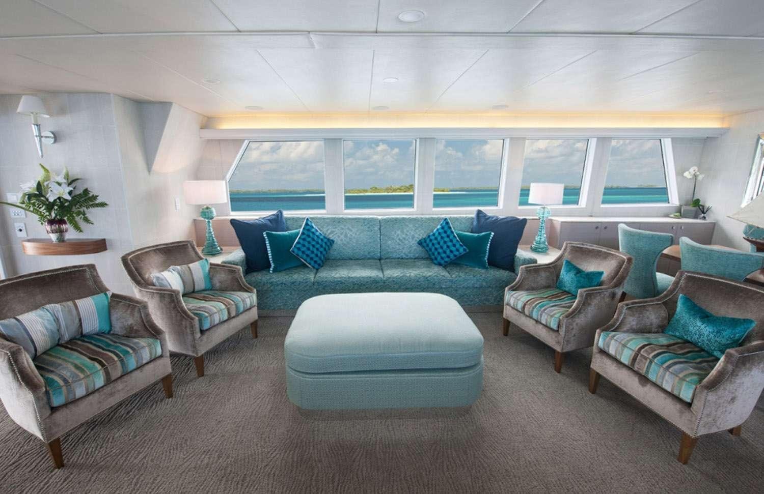 a living room with couches aboard SHORETHING Yacht for Charter