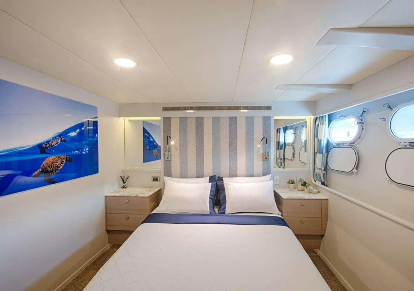 a bedroom with a large bed aboard SHORETHING Yacht for Charter